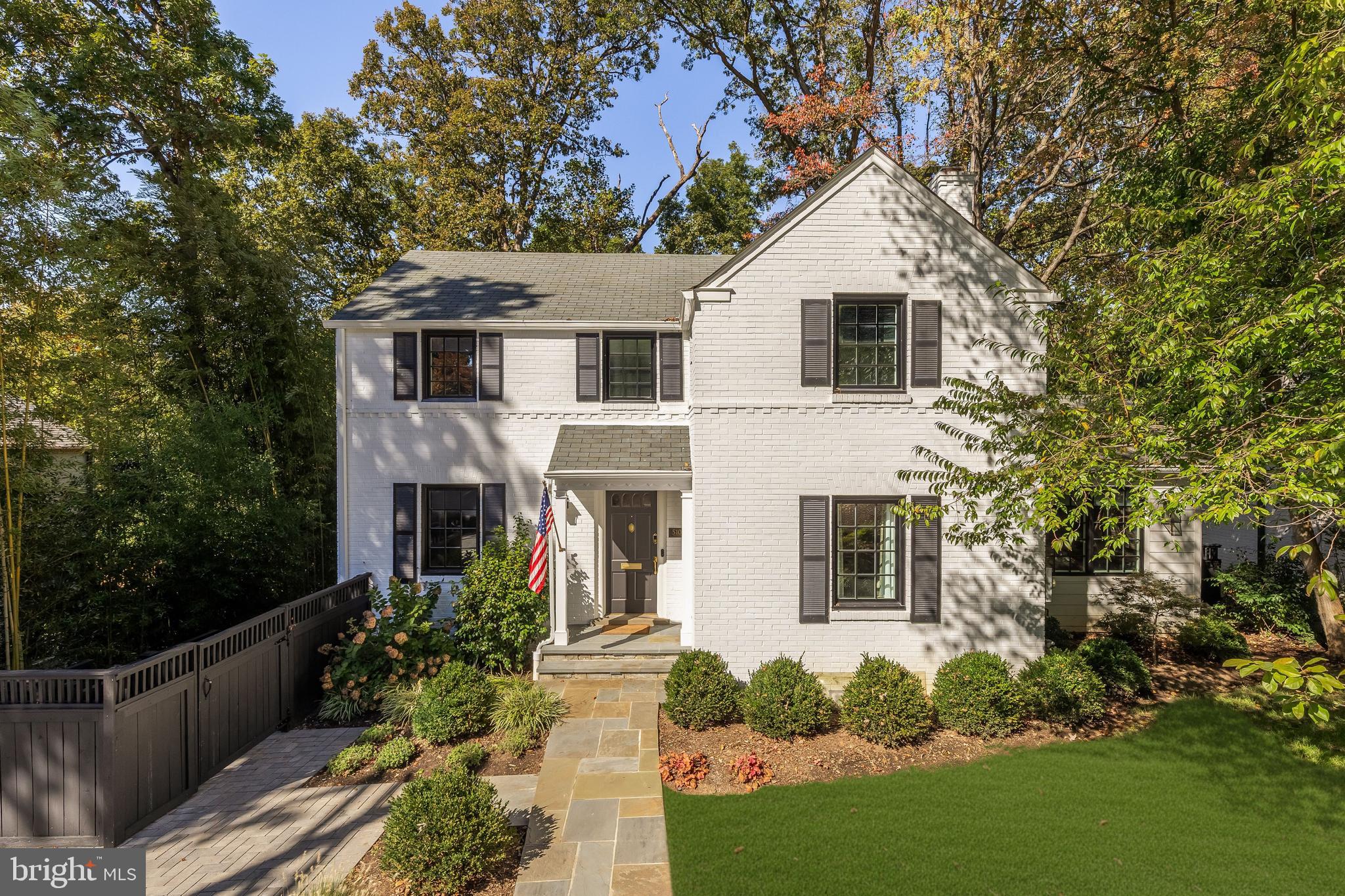 Perfectly positioned in one of Bethesda’s most coveted neighborhoods, 5106 Brookview Drive blends timeless elegance with modern refinement. Set within the sought after Westgate community, known for its tree lined streets, neighborhood pool, and proximity to Westbrook Elementary and Westland Middle School, the Capital Crescent Trail, Little Falls Trail, Little Falls Library and Westbard Square, this classic white brick colonial has been thoughtfully updated to meet the demands of today’s lifestyle while preserving its enduring charm.
The home’s inviting curb appeal features manicured, illuminated landscaping; an underground irrigation and drainage system; a new paver driveway; and a flagstone walkway leading to the refreshed white façade framed by dark shutters and new Pella windows.
Inside, the residence showcases new millwork, fixtures, and finishes throughout, along with a reconfigured layout that enhances flow and functionality. The gracious foyer opens to formal living and dining rooms in a traditional center hall design. The dining room, enveloped by wooded views and a deep green palette, offers moody sophistication, while the spacious living room centers on a wood burning fireplace and opens to a tranquil private office.
The expanded kitchen is a showpiece, featuring white Shaker cabinetry, a contrasting island with honed black stone countertops, and professional grade appliances. A custom banquette, coffee bar, and breakfast area with a built in window seat connect seamlessly to the new deck, ideal for indoor outdoor living.
Upstairs, the primary suite includes an enlarged walk in closet and a marble bath with double vanity and glass shower. Two additional bedrooms share an updated hall bath. The lower level offers a large recreation room, a newly finished fitness room, a private guest suite, and a dedicated laundry.
Outside, the fenced rear lawn features a generous patio for al fresco dining, a new deck, and a custom storage shed.
Blending thoughtful design, quality craftsmanship, and an exceptional location, 5106 Brookview Drive embodies the best of Bethesda living.