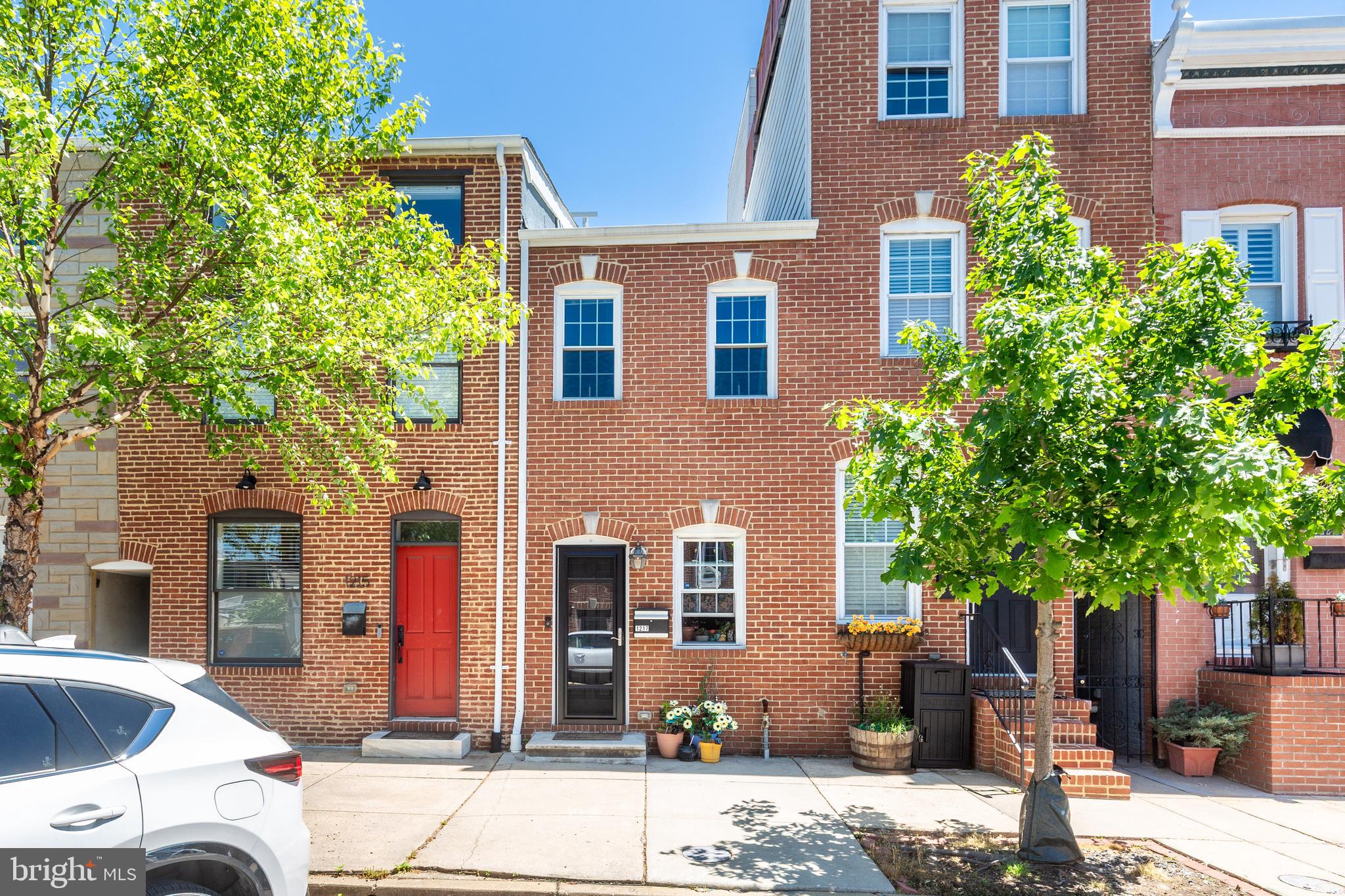 Discover the perfect blend of historic charm and modern city living in this beautifully updated and well maintained Federal style townhouse located in the heart of Baltimore City’s highly desirable Canton neighborhood. Thoughtfully designed for comfort and functionality, this inviting home combines timeless character with modern conveniences for effortless everyday living. Inside, the home offers a warm and welcoming layout with flexible living spaces ideal for entertaining or relaxing at home. The kitchen provides space for a dedicated breakfast nook or stylish coffee bar setup, while tasteful updates throughout create a true move in ready opportunity without sacrificing the classic charm that makes Baltimore rowhomes so desirable. Adding even more functionality, the home includes a convenient sally port that provides valuable extra storage space for bikes, outdoor gear, tools, or seasonal items while enhancing the practicality of everyday city living. Step outside to enjoy your own private back deck patio, an ideal extension of the living space perfect for outdoor dining, entertaining, or simply unwinding after a long day. Rounding out the home is the rare convenience of 1 assigned parking space, offering valuable ease and accessibility in city living. Situated just moments from The Shops at Canton Crossing, residents enjoy convenient access to shopping, dining, groceries, fitness studios, and everyday essentials all within one of Baltimore’s premier retail destinations. Fitness enthusiasts will appreciate being close to Merritt Athletic Club, known for its expansive gym facilities, rooftop pool, group fitness classes, and wellness amenities. Commuters benefit from quick access to I-95 and other major commuter routes, making travel to Downtown Baltimore, Federal Hill, Locust Point, and surrounding areas seamless and convenient. Canton’s vibrant and walkable atmosphere places countless neighborhood favorites just steps from your front door. Enjoy local dining and nightlife at The Dive, a beloved retro inspired neighborhood spot known for its lively ambiance, creative cocktails, and popular food menu. Residents are also moments from nearby favorites including Ellie’s Lighthouse and other popular waterfront destinations throughout Canton. Outdoor enthusiasts and pet owners alike will appreciate the home’s close proximity to Bonvegna Field and the popular Canton Dog Park, which features spacious fenced play areas, shaded seating, and a vibrant community atmosphere for both residents and their four legged companions. With its ideal combination of updated interiors, private outdoor space, additional storage, dedicated parking, and unbeatable walkability to Canton’s restaurants, parks, shopping, and waterfront attractions, this exceptional townhouse offers the very best of Baltimore City living in one of its most sought after neighborhoods. Please contact Listing Agent Nick Prell for private showing requests or questions about the property!