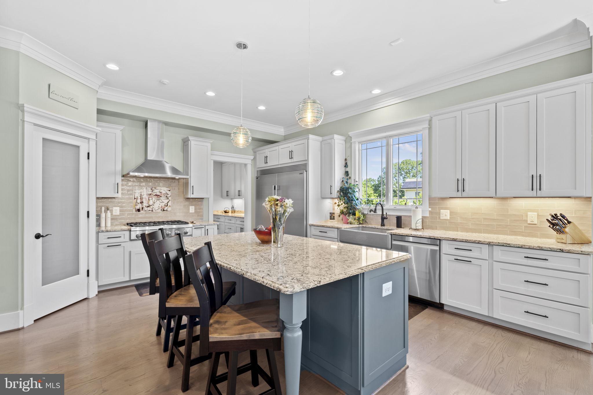Luxury living meets cozy charm... This custom-built home offers the rare opportunity of main level living, with the Primary Bedroom and one set of washers and driers on the entry level. Better than new construction, this 7-year-young custom beauty has what many new construction homes do not: a level, lush acre of land with mature landscaping and thick, leafy green grass and a mostly finished basement with a bit of customizable area, perfect for an exercise room and/or a media room (currently part of the unfinished area houses a greenhouse!). It appraised for $1,750,000 in 2022 and since then the numerous upgrades throughout the home simply add to its specialness. As a new house, it was built with top-notch design elements and materials, and in the past two years, more thoughtful work has been done. About $150,000 in upgrades which include designer lighting fixtures (the Murano glass chandelier over the kitchen table is stunning) and ceiling fans, refinished wood floors, a new paver front walk and repaved driveway, a top-of-the-line security system, the latest and greatest garage door openers, an EV charger, LED lightbulbs throughout and, last but not least, solar panels. Take the stunning custom craftsmanship of this beautiful home, add all of these recent upgrades from the past two years, and you have the perfect new home awaiting you. And unlike so much of the new construction in northern Virginia, this home has so much yard! You have a full front yard and an outfield of a backyard, a full acre of land and perfect outdoor spaces - an expansive front porch and a huge back deck - from which to enjoy the bucolic views. Inside the house, the outside streams in - sunny and bright throughout the day. The main floor is so welcoming, with spaces open and flowing, but with boundaries that create coziness. And the main floor Primary Suite and laundry room make this the perfect home in which to not do stairs if you don’t want to! But you won’t want to miss the three large ensuite bedrooms/bathrooms on the second floor (and the second laundry room), nor the Rec Room, wet bar with beverage fridge, entertainment zone, the fifth bedroom and fifth full bath that you will find in the basement. Full of design, details, finishes, upgrades, and room for life to unfold, this house is the perfect home. The perfect home in the perfect place in the acclaimed Woodson school pyramid. It is so close to everything (4 minutes drive via back roads to Wegmans!!!), with easy access to major thoroughfares, shopping and dining, yet, when you are home, you will feel as though you live in a small rural community, where life moves slowly and you are rooted in your land. What’s not to love? There is a ring doorbell in use. The last three photos are concept photos to show the house with different exterior colors.