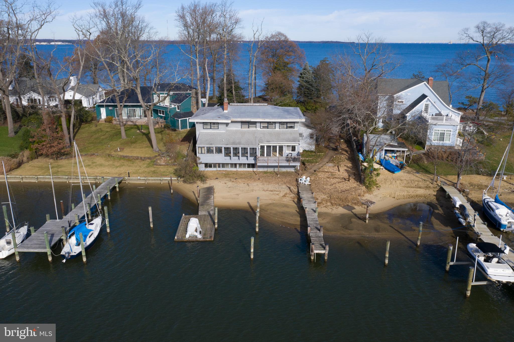 Waterfront Lots are hard to find, especially when the water views are so beautiful from your front and back door! Build your dream home on this fabulous lot that overlooks the Chesapeake Bay and features a pier and floating dock on Lake Ogleton in the waterfront community of Annapolis Roads. The home on the property is  being sold "as is". The value of the property is in the land.  Lake Ogleton is known as a "safe hurricane hole". Wildlife and tranquility abound. Special Taxing District. Home has been staged for photos but is most likely a tear down.