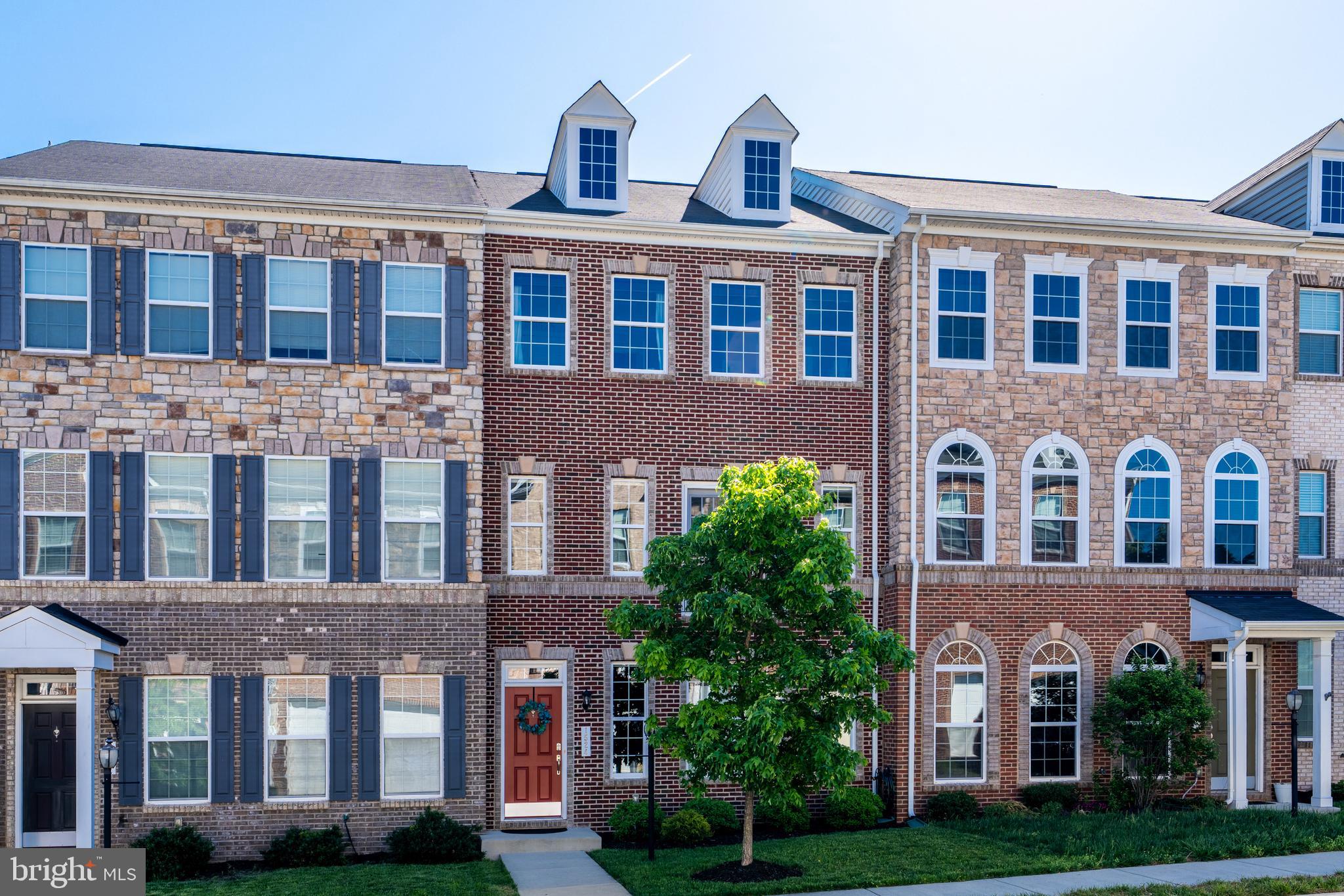 Luxury Living in River Pointe! Enjoy comfort, convenience and designer touches in a vibrant community setting. Built in 2014, this three-level townhome features a 10-foot bumpout on every level, creating a contemporary open floor plan with high-end finishes and versatile spaces for both entertaining and everyday life. Tree-lined streets welcome you home in this well-maintained, landscaped community, and a rear-load oversized two-car garage provides ample parking and storage. Inside, the lower level includes a bedroom, full bathroom, and a large storage closet, all set against hardwood floors and designer wallcoverings that continue upstairs through the main living areas. Natural light fills the main level’s open layout, creating a spacious living area with room for an office nook, with a powder bath and coat closet nearby. The gourmet kitchen is equipped with granite countertops and island, ample high-quality cabinetry, and a suite of stainless steel appliances. Seamlessly flow between the kitchen, dining space, and the family room with sophisticated coffered ceilings above a cozy fireplace. Sliding glass doors open directly to a balcony, inviting easy indoor-outdoor living and entertaining. Upstairs, hardwood floors transition to plush carpets in three bedrooms, with the laundry room also conveniently located on this level. The luxurious primary suite features dual walk-in closets with professional organizers, wainscoting in the bedroom, and a spa-like primary bath with a quartz double-sink vanity, oversized corner tub, and frameless glass shower. Two more spacious bedrooms on this level each feature closets with built-in organizers and share the home’s third full bath. Enjoy outdoor living in this tranquil community from the private comfort of your balcony as well as a ‘tot lot’ park nearby. The River Pointe community features an additional playground, pool, clubhouse, tennis and basketball courts. Located near the Potomac River, this sought-after setting offers natural beauty alongside modern conveniences, just moments from local parks, schools, shops and restaurants, as well as historic downtown Leesburg and major commuter routes. Experience the perfect balance of space, style, and community. This one checks all the boxes!
