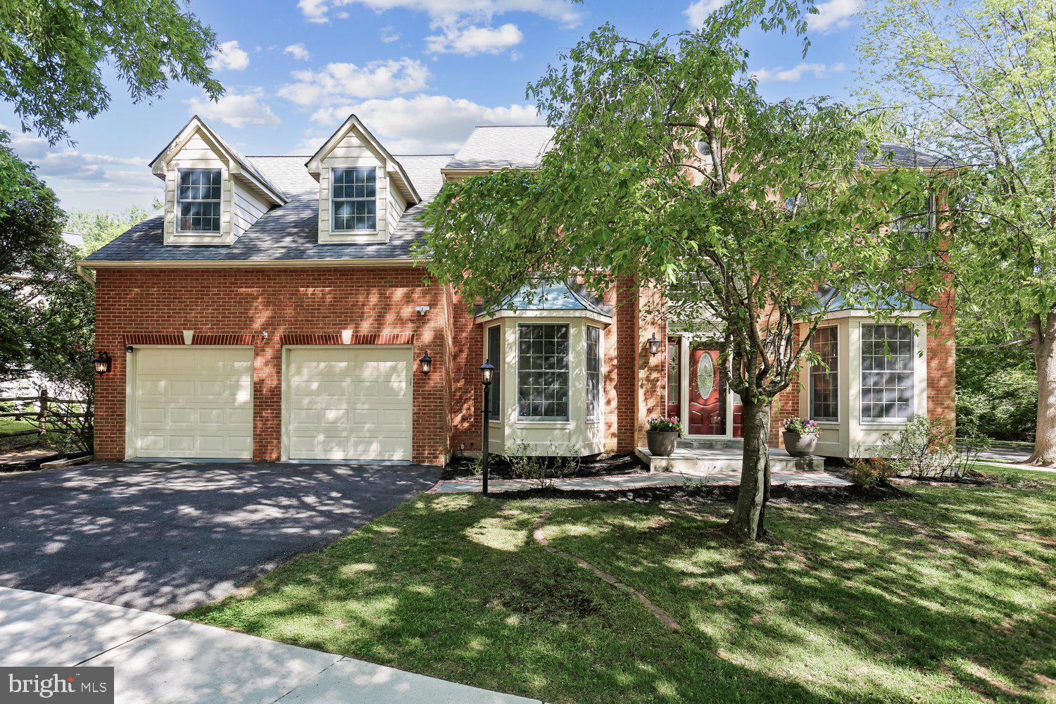 Unbelievable opportunity to own a detached home on a premium cul-de-sac lot backing to a conservation area in Rose Hill Falls. This stunning 4BR+den/4.5BA brick-front colonial with a two-car garage was built by the Magruder Companies, and the quality of craftsmanship is everywhere. Designer-home appeal includes a great sense of light and spaciousness with 9-foot, 10-foot, and cathedral ceilings; skylights; new custom painting; refinished hardwood flooring throughout most of the main level; new designer carpeting in family room, study, and both upper and lower levels; porcelain, ceramic and LVT in all baths; elaborate molding package throughout; remodeled kitchen with white cabinets, granite countertops, stainless appliances, and 10-ft. center island opening to a step-down family room with stone fireplace; glorious sunroom/breakfast area with skylights and sliding glass door to rear deck and private yard backing to conservation area. Flagstone front walkway and front stoop; grand two-story foyer entrance with elegant chandelier, curved staircase, coat closet and renovated powder room; open formal living room with bay window and adjoining dining room with bay window; main level study with built-in bookshelf and bay window; gourmet kitchen with granite countertops, upgraded stainless appliances, 10-ft. granite center island/breakfast bar, recessed lighting, and pantry; sunroom/breakfast room off of kitchen with walls of windows, recessed lighting, two skylights, ceiling fan, and sliding glass doors to deck; step-down family room with 10-foot ceiling, French doors to deck, and stone wood-burning fireplace with raised slate hearth and wood mantel; laundry/mudroom off of kitchen with new LVT flooring, washer/dryer, utility sink, laundry chute, and access to two-car garage; curved solid oak staircase to upper level from foyer; enormous (28’ x 22’) primary bedroom suite with cathedral ceiling, private sitting room/office, and dormer storage closet; double glass doors to dressing room with walk-in closet, two skylights, and vanity with makeup counter; primary bathroom with cathedral ceiling, two skylights, double vanities, walk-in shower, jacuzzi whirlpool tub, and separate water closet; three additional bedrooms on the upper level and two additional beautifully renovated full baths with designer porcelain tile, quartz vanities, backlit/heated mirrors, and high-end finishes; lower-level recreation room with recessed lighting and newly remodeled full bath; multiple unfinished storage/utility areas for future expansion (media room, exercise room, or wine cellar) with painted concrete flooring and walk-up stairs to Bilko door exit; architectural shingle roof (2017), dual-zone HVAC with natural gas furnace and CAC on main level (2012), electric heat pump on upper level (2009), and newer 75-gallon water heater (2024).  Without leaving the neighborhood, there are over a mile of bucolic walking/bike paths, forested conservation areas, sidewalks, two tot lots, a private tennis court, and a basketball court.  Adjacent to the development sits the City of Rockville's Bullard Park at one end of the neighborhood and all the sports fields, track, and tennis courts of Julius West Middle School on the other side.  Be part of the vibrant Rockville Town Center featuring shopping, fine restaurants, sidewalk cafes, the Rockville Regional Library, Regal Cinemas, and other entertainment and cultural facilities.  Less than a mile from the Rockville Metro (Red Line) for those looking to commute via mass transit.