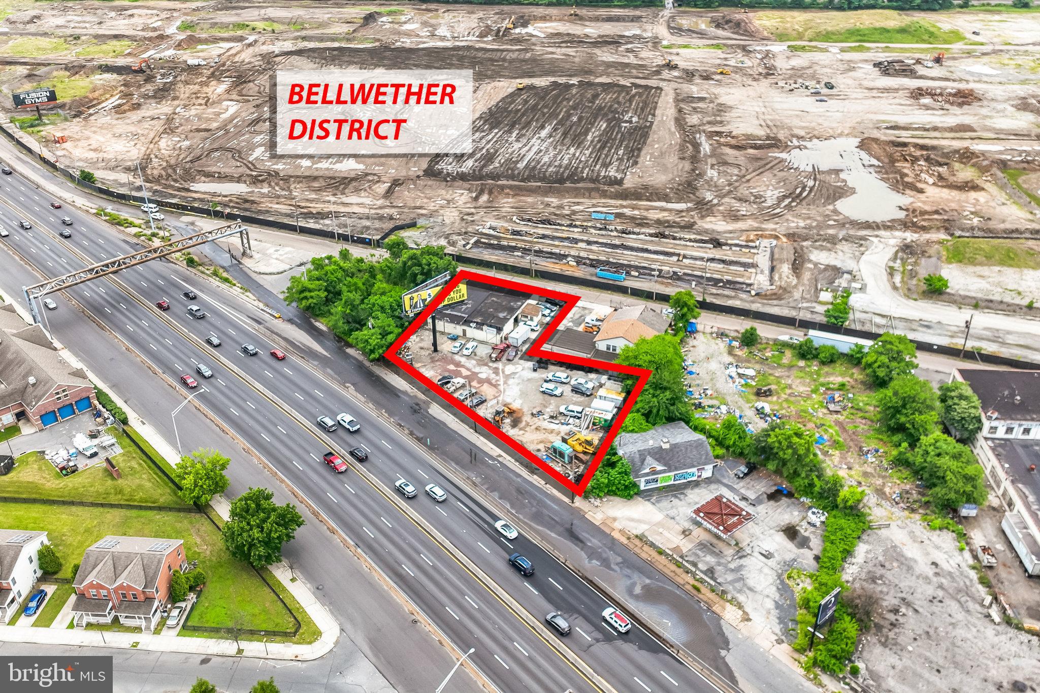 Construction has begun in the rapidly developing Bellwether District. This property offers a rare investment opportunity featuring two street-to-street parcels totaling approximately 0.55 acres with multiple income streams.The ±4,800 SF warehouse is leased on a yearly basis for $4,500 per month and includes a kitchen area and three overhead doors. The adjoining lot is rented for $1,500 per month. In addition, a V-sign on the property produces $2,041.67 per month, with approximately 3.5 years remaining on the lease. The sign company also contributes $9,800 annually toward real estate taxes.Total monthly income is $8,041, with $9,800 per year in tax reimbursement. There is potential to convert the sign to digital, which could significantly increase rent and property value.Located along one of Philadelphia’s highest-traffic corridors near I-676, this property is positioned for continued growth and long-term appreciation within the expanding Bellwether District.