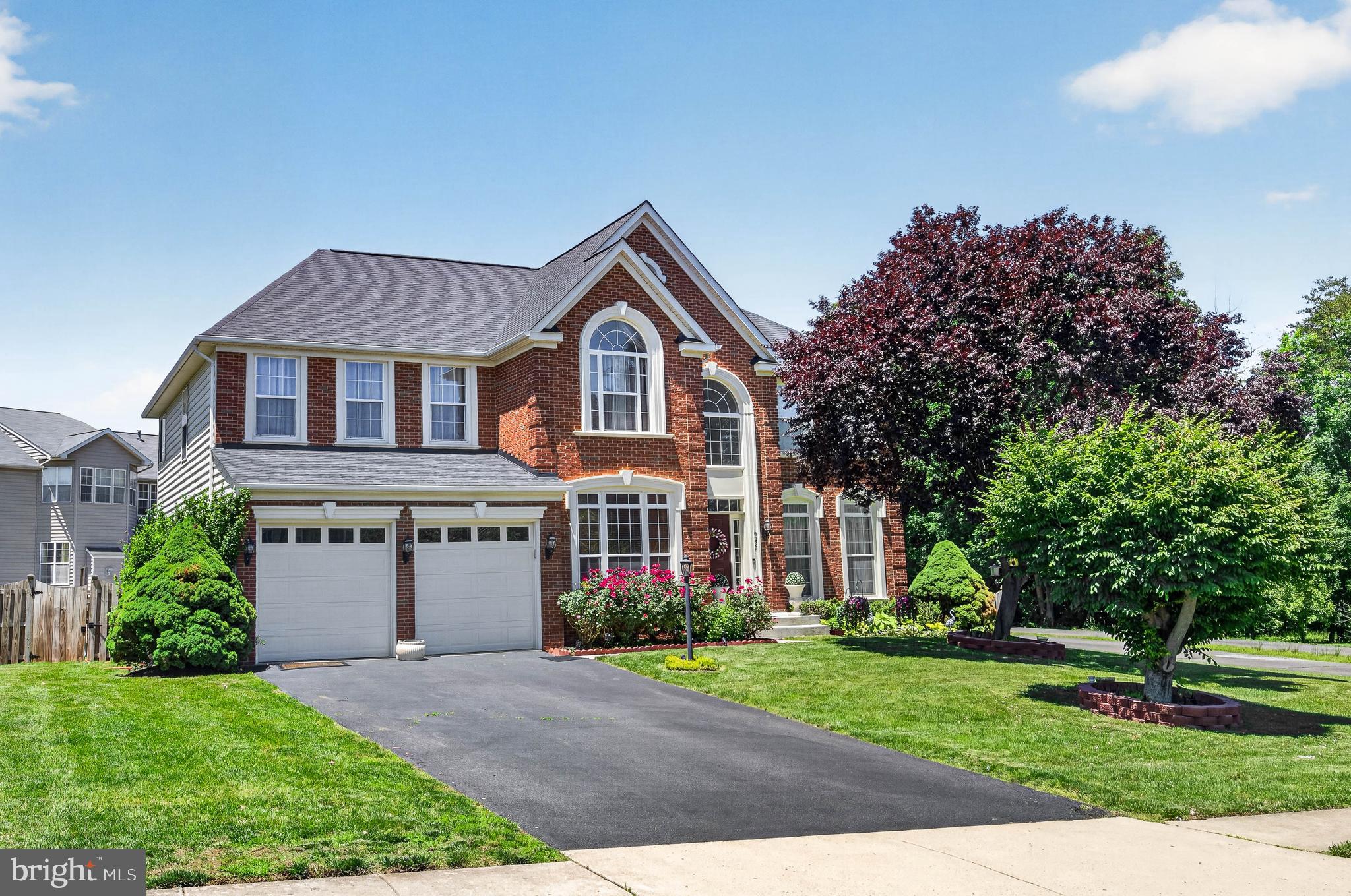 Welcome to this stunning brick-front Colonial in the highly sought-after Crossman Creek community. Ideally located just minutes from shopping, dining, Old Town Manassas, Virginia Gateway in Gainesville, downtown Haymarket, three VRE stations, and major commuter routes, this home offers both convenience and exceptional living space.

Boasting nearly 5,000 finished square feet on three beautifully finished levels, this sun-filled home features a dramatic two-story foyer, 4 spacious bedrooms, and 4.5 baths. The main level offers a private study, formal living and dining rooms, and a gourmet kitchen featuring recently installed quartz countertops, stainless steel appliances, double ovens, and freshly painted cabinetry. The oversized family room with a cozy fireplace creates the perfect gathering space, while the large Trex deck is ideal for outdoor entertaining.

Upstairs, the luxurious owner's suite includes a generous sitting room and spa-inspired bath. A secondary suite with a private bath, along with two additional bedrooms connected by a Jack-and-Jill bath, complete the upper level.

The finished walk-out lower level is designed for entertaining and flexible living, featuring a large recreation room with a custom bar and surround sound system. Also on this level are a fifth bedroom or den, a second laundry room that can also serve as an exercise space, and direct access to the fenced backyard.

Recent updates include a roof approximately 4 years old, HVAC system approximately 6 years old, cooktop approximately 5 years old, new carpet in the lower-level den, and fresh paint throughout. Truly move-in ready, this exceptional home combines space, comfort, and an unbeatable location.

Don't miss the opportunity to make this beautiful home your own.