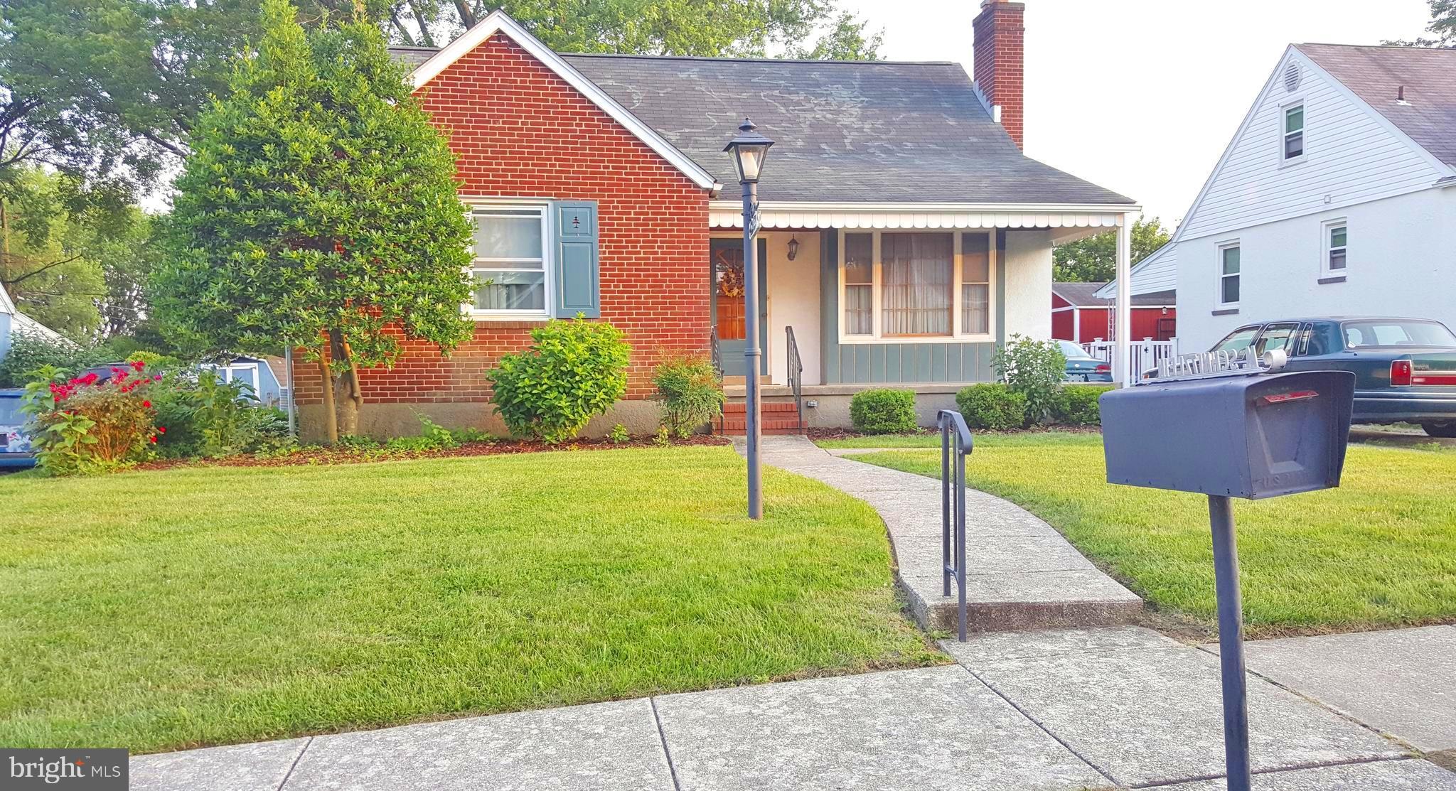 Charming porch front home with off-street parking and a fenced back yard. Cozy fireplace in the living room. Eat-in kitchen. Separate formal dining room. Hardwood under carpet, 2 beds and full bath on main level. Spacious finished basement with large family room, bar for entertaining, separate laundry room, workshop, storage & convenient half-bath. Walk-up unfinished 2nd floor. As-Is estate sale.