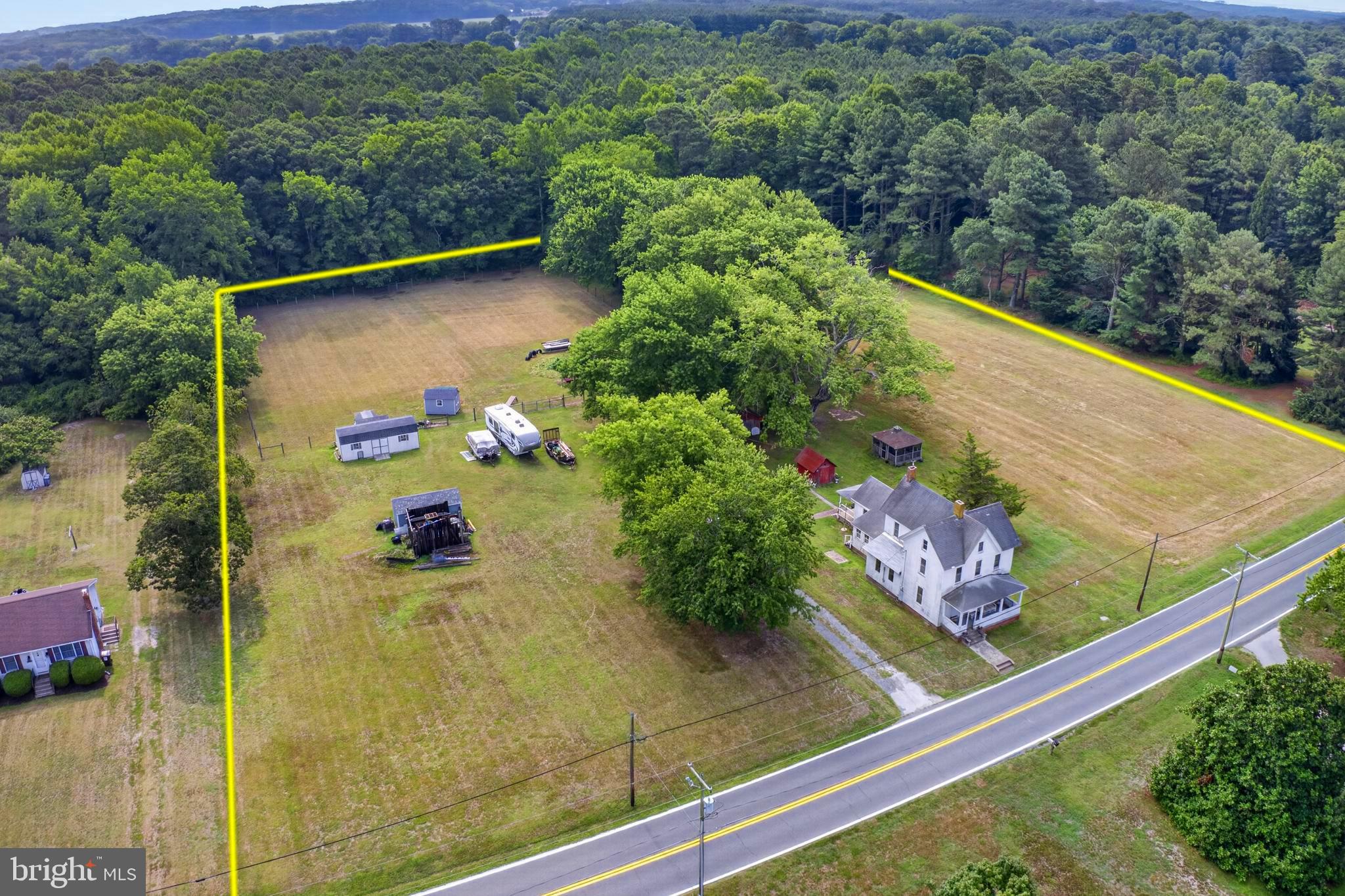 Rare Opportunity - roomy 3-4BR Farmhouse on 3.68+ ACRES with fenced pastures, backing to trees. Your own Worcester County homestead. Incredible location - convenient to shopping, dining, events, but you'll feel tucked away in your own little corner of the world.  Just 6mi NW to Historic Downtown Snow Hill on the banks of the Pocomoke River or SE to George Island Landing for an afternoon on the bay. Quick 16mi trip to NASA Wallops Island, 17 to beloved Chincoteague Island and their famous wild ponies, 28 to Ocean City for boardwalk fun! Your farmhouse has a surprisingly flexible floorplan, and some nice updates like central air conditioning, along with plenty of original charm like wood flooring and trim throughout most of the home, and multiple porches. First floor offers a foyer, spacious living room currently used as a primary bedroom, large family room with a separate sitting room area, complete with a pellet stove that warms the whole space in the winter. Formal dining room and the most darling kitchen, updated with stainless steel appliances, and breakfast nook. Full bathroom with tile flooring, tub/shower combo. Laundry room with plenty of space for additional storage. Upstairs, 2 large bedrooms, a 3rd smaller room still comfortably fits a twin bed and dresser. Permanent steps to the attic, used as the current owners' hobby and craft room, plus good-sized areas for storage. The front porch is a great spot to watch your neighbors head into your little town of Girdletree, or the 4-5mi out to Worcester Hwy / Rt 113. Relax on your back porch with an iced tea and enjoy the sights and sounds of your own little farmette - horses, chickens, goats - no HOA to restrict what you do on your private acreage. Don't miss out on this opportunity to own your own little slice of Eastern Shore Life. Close to everything Worcester County has to offer - boating, world-class fishing, crabbing, wildlife estuaries, incredible state parks - a true paradise for nature lovers, photographers, boaters - anyone who wants to enjoy the more relaxed pace of the Eastern Shore. Just 2-3 hours to major metro areas - Virginia Beach/Norfolk, Washington DC, Baltimore, Philadelphia, NYC. Life in Worcester County is good - from the beaches to the bays & beyond! Premises address is 2924 Snow Hill Road, Snow Hill, MD 21863 - but mailing address is 2924 Snow Hill Rd, Girdletree, MD 21829.  Sizes, taxes, distances are approximate. Outlines on aerial photos are approximate, and for reference only.