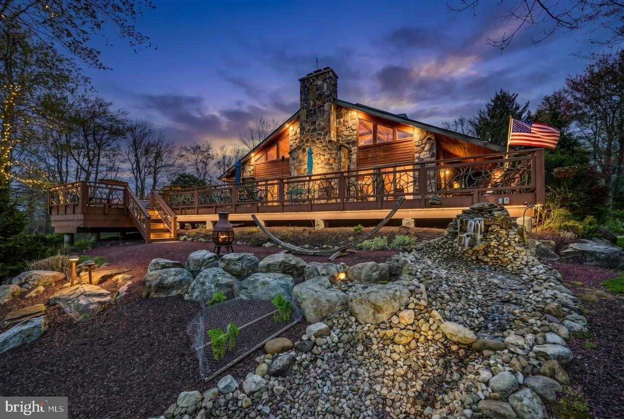 ACTIVE w CONTRACT: Back up offers only at this time.  Serenity in the Pocono Mountains--Golf Course Living at Its Finest! Perfectly positioned on the 9th hole, this exceptional over 5000 Sq St. Cedar home on 1.24 acres with NO HOA offers breathtaking fairway views and a peaceful mountain setting. A paved drive leads you to this expansive retreat featuring a massive open floor plan highlighted by a dramatic floor-to-ceiling stone, wood-burning fireplace and rich wood flooring throughout the main living space. The heart of the home is a beautifully appointed kitchen with granite countertops, double oven, and seamless flow into a wet bar--perfect for entertaining. Enjoy year-round relaxation in the 4-season room or step outside to the expansive deck complete with hot tub, ideal for soaking in the serene surroundings on the hammock next to the water fall feature. The main level features a luxurious primary bedroom suite with private bath, a powder room, convenient butler's quarters and private study. Upstairs, an open balcony overlooks the grand living area and leads to four spacious bedrooms--each with its own private adjoining bathroom--plus access to a storage attic. The lower level is designed for fun and functionality with a large game room, bar area, storage room, utility space, and a 2-car garage. Additional highlights include central heat and air main level, a storage shed, and a Simply Safe secure alarm system. Enjoy a lifestyle of convenience and recreation with a private pathway to the Sunset Green Restaurant and Split Rock Golf Club. Ownership includes access to Lake Harmony--a motorboat lake--plus you're just minutes from skiing, water parks, and local nightlife. See it to believe it--this is Pocono living at its best!
