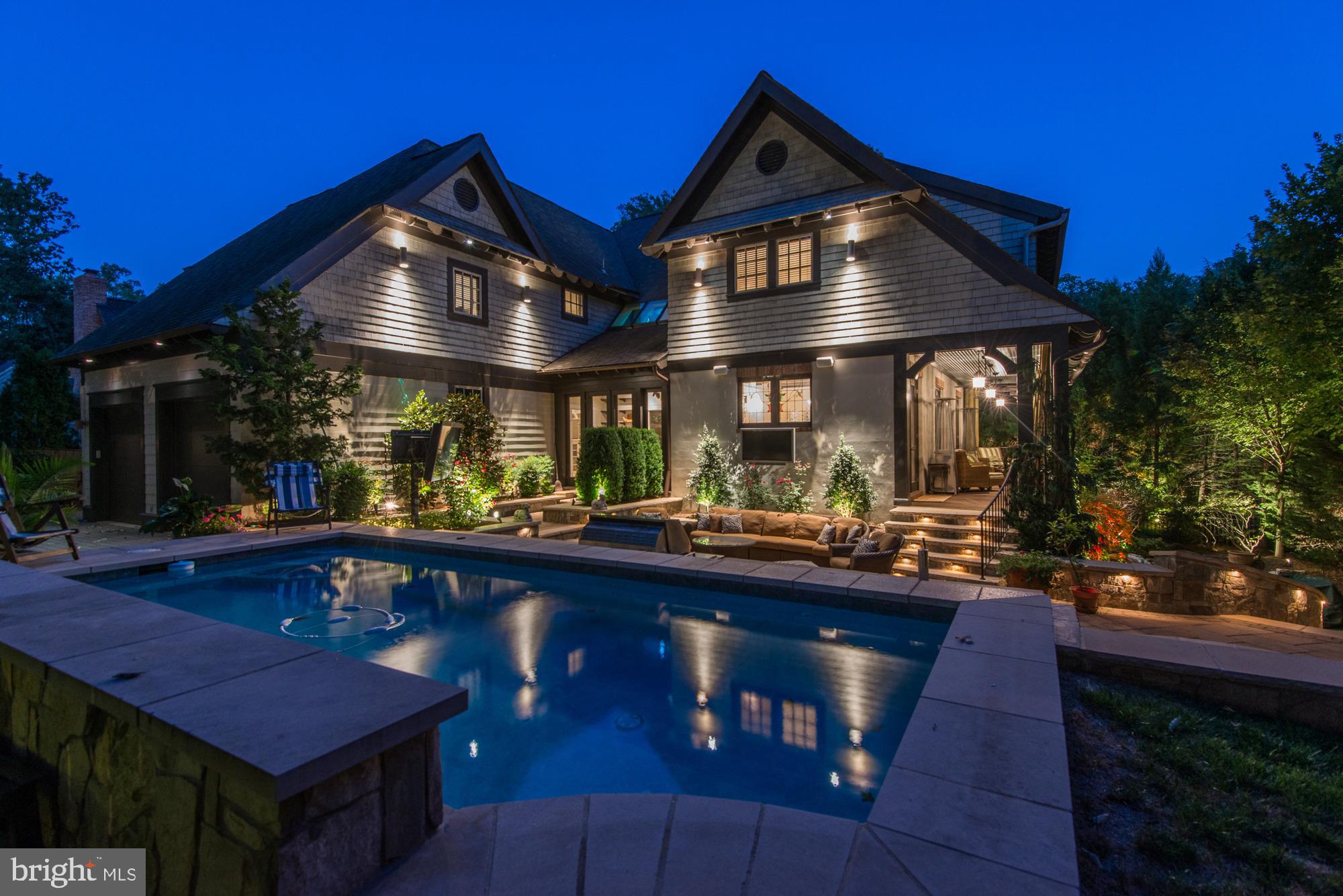 This quintessential Morris-Day home was once the builder's personal residence, and designed after his childhood home in England. Over the years, improvements such as current finishes, hardware and lighting, a generator and extraordinary outdoor living & entertaining spaces have been added, all the while retaining the charm and character for which Morris-Day is known. The details such as extensive wood beams, paneling, and molding rich in color coupled with high ceilings, uniquely shaped openings, custom fireplace mantles, expansive windows, skylights, unique light fixtures, window treatments & built-ins continue to showcase the Morris-Day tradition.  The Main Level features a two-story Foyer loaded with natural light coming from the skylight ceiling, a Great Room and Dining Room with beamed ceilings, Tiffany glass windows and glass doors to the Porch, a Butler’s Pantry, Chef’s Kitchen, Caterer’s Kitchen, Breakfast Room, Living Room with a fireplace, and two sets of stairs that lead both to the upper and lower levels. The Upper Level offers 5 bedrooms, including a gracious Primary Suite with a large shower that includes glass doors to a Juliet Balcony, a soaking tub, sconce wall lighting through-out, a Large primary closet, plus two secondary closets, and washer and dryer. The four Secondary Bedrooms are all graciously sized with ample closet space, as well as an upper level Family Room/Office that offers flexible space (could be an addition to the primary closet) and a fully plumbed and greenhouse room with potential to become a laundry room or additional bath!   The walkout Lower Level features a fully loaded Wet Bar, designed like an English Pub with a refrigerator, dishwasher, two keg taps, and custom built liquor cabinet with Tiffany stained glass doors. The open floor plan offers a Billiard’s Room, Recreational Room with a gas fireplace, Home Theater, Wine Cellar, Wine Tasting Room, and two sets of double glass doors that lead out to an outdoor oasis loaded with professional landscaping, hardscaping complete with waterfalls, and a pond meant for Koi, two outdoor TVs and a firepit. The outdoor swim up bar/ kitchen offers a built-in grill beverage refrigerator, and keg tap all with stone counter beneath an in-ground spa with waterfalls and jets! With its incredible privacy, indoor and outdoor living, this exceptional property is perfect for entertaining as well as formal entertaining!  Sited beautifully and privately (with an automated driveway gate) on one-third of an acre in the sought-after community of Franklin Park, known for its lush natural landscape, mature trees, and charming rolling hills, this home offers access to the best of McLean with its close proximity to all that Downtown McLean has to offer, and is also ideally situated just minutes to the George Washington Parkway, 1-66, Tyson’s Corner, and the Capitol Beltway.