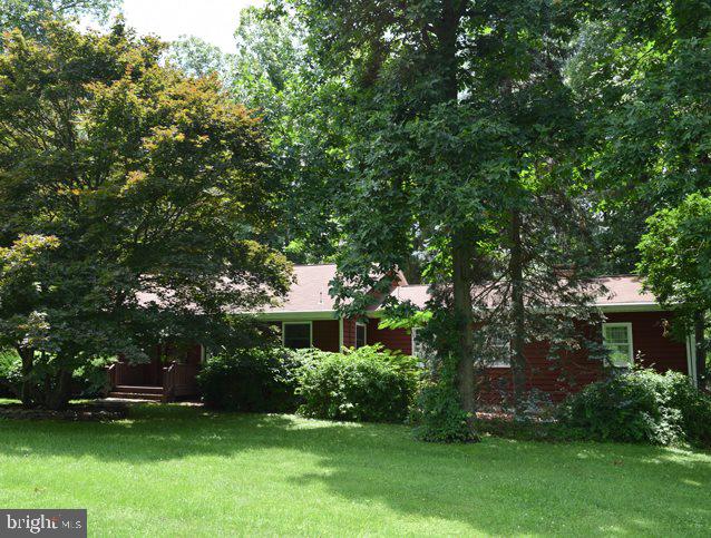 Littlestown - Own your own private, wooded 2.74 acre lot... It's gorgeous... This park like setting includes a charming 3 bedroom rancher with large picture windows throughout to enjoy the scenery. There is a spacious paver patio and rear deck with a pergola ready for entertaining. The perfect weekend get-a-way or convenient MD commuter access via Route 97.