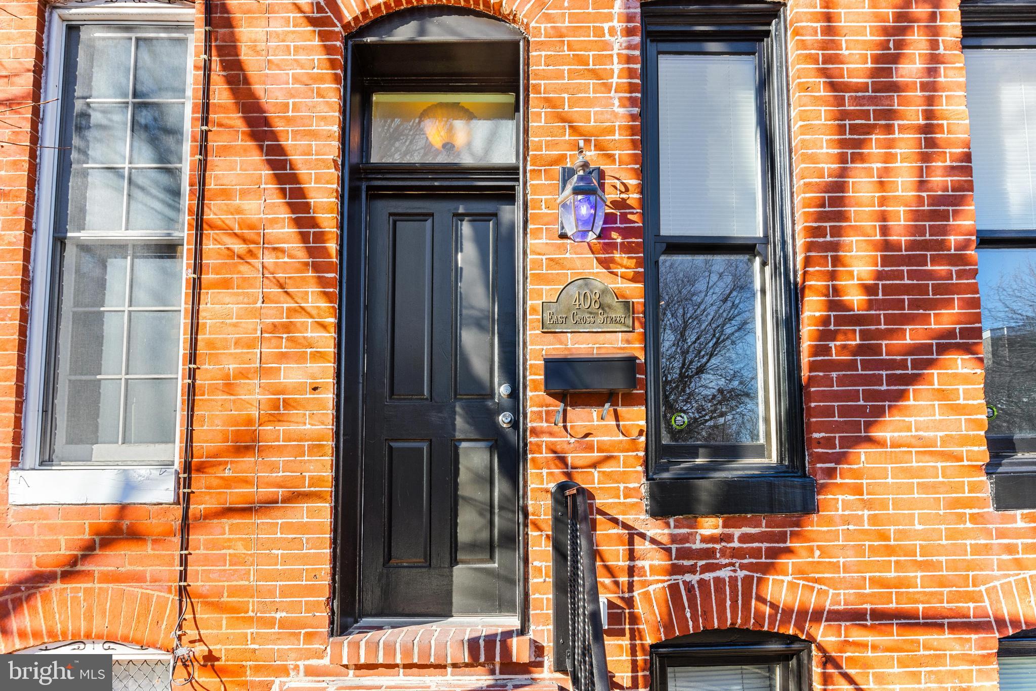 Welcome to 408 E Cross Street, a beautifully renovated Townhome in the heart of Federal Hill! This home seamlessly blends historic charm with modern updates, featuring an enclosed entryway that leads into an open floor plan. The living area is highlighted by a decorative fireplace and mantel, adding warmth and character. The spacious kitchen offers ample white cabinetry, stainless steel appliances, a pantry, and room for table space—perfect for both everyday living and entertaining. A convenient main-level laundry room and half bath add to the home's functionality.

Step outside from the kitchen onto the rear deck, which overlooks a fenced-in patio, providing a great space for outdoor enjoyment. The upper level boasts two generously sized bedrooms, each with access to a full bathroom. The finished basement provides additional living space, offering endless possibilities for a recreation room, home office, or extra storage.

Don’t miss this incredible opportunity!