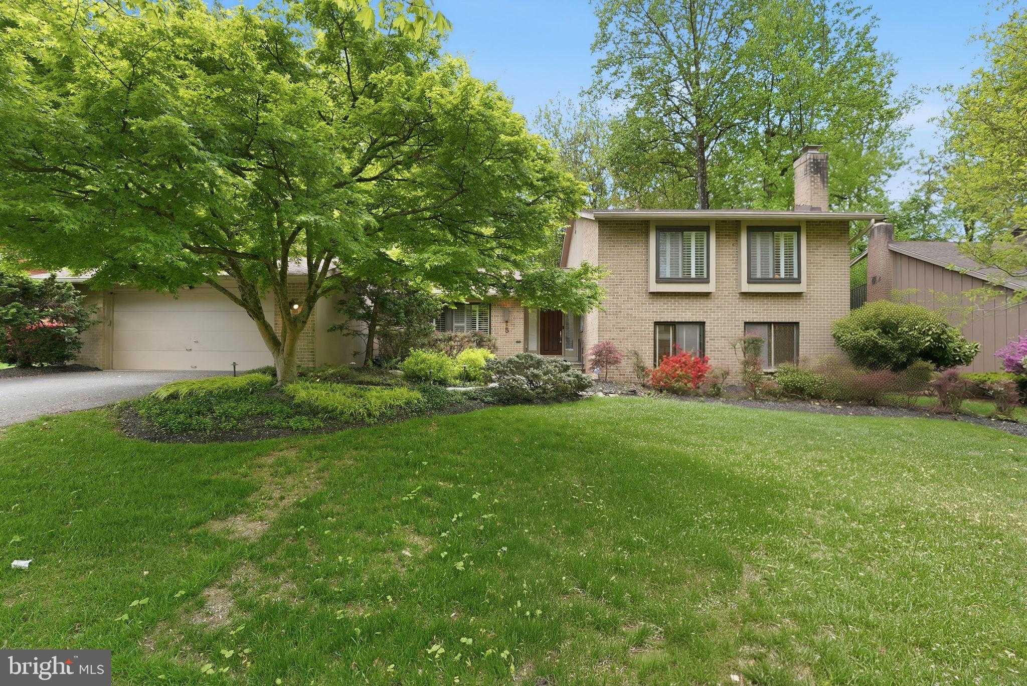 Tucked beneath mature trees on a beautifully landscaped lot backing to parkland, this striking contemporary residence offers exceptional space, style, and thoughtful updates throughout. A dramatic front foyer welcomes you inside and flows seamlessly into the inviting family room featuring custom built-in cabinetry and a fireplace. Expanded and designed for both everyday living and entertaining, the chef’s kitchen is a true showpiece with sleek contemporary finishes, a large center island, generous table space, and direct access to the screened porch overlooking the private wooded setting. Just beyond the kitchen, a spacious mudroom connects to the two-car garage and is complemented by a full bath.
The step-down lower level offers an impressive great room with custom built-ins, the home’s second fireplace, and stylish grasscloth wallpaper. This level also includes two flexible den/bedroom spaces, a full bath, powder room, and an oversized laundry room. Upstairs, the expanded primary suite serves as a private retreat with a huge walk-in closet and spa-inspired bath. Two additional bedrooms and a full bath complete the bedroom level.
The additional lower level provides even more living space with a large recreation room, bonus room, and utility/storage area. Outdoor living is equally impressive with a screened porch, expansive deck, professional landscaping, hardscaping, and an underground sprinkler system. Major updates include a new roof and gutters (2021), new sewer pipe (2025), HVAC (2013), hot water heater (2015), new cololing system in sub zero refrigerator, new dishwasher motor/pump, new thermostat with Lutron Cuséta wireless switches that responds to voice commands through Alexa, and replaced Thompson Creek Window Company windows. A rare opportunity to own a distinctive home with space, privacy, and timeless design. Enjoy access to the 42-acre Potomac Woods Park with its walking trails, sports courts, and playground. Ideally situated within walking distance to Seven Locks Shopping Center, Park Potomac  and offering easy access to Interstate 270 and the Capital Beltway (I-495).