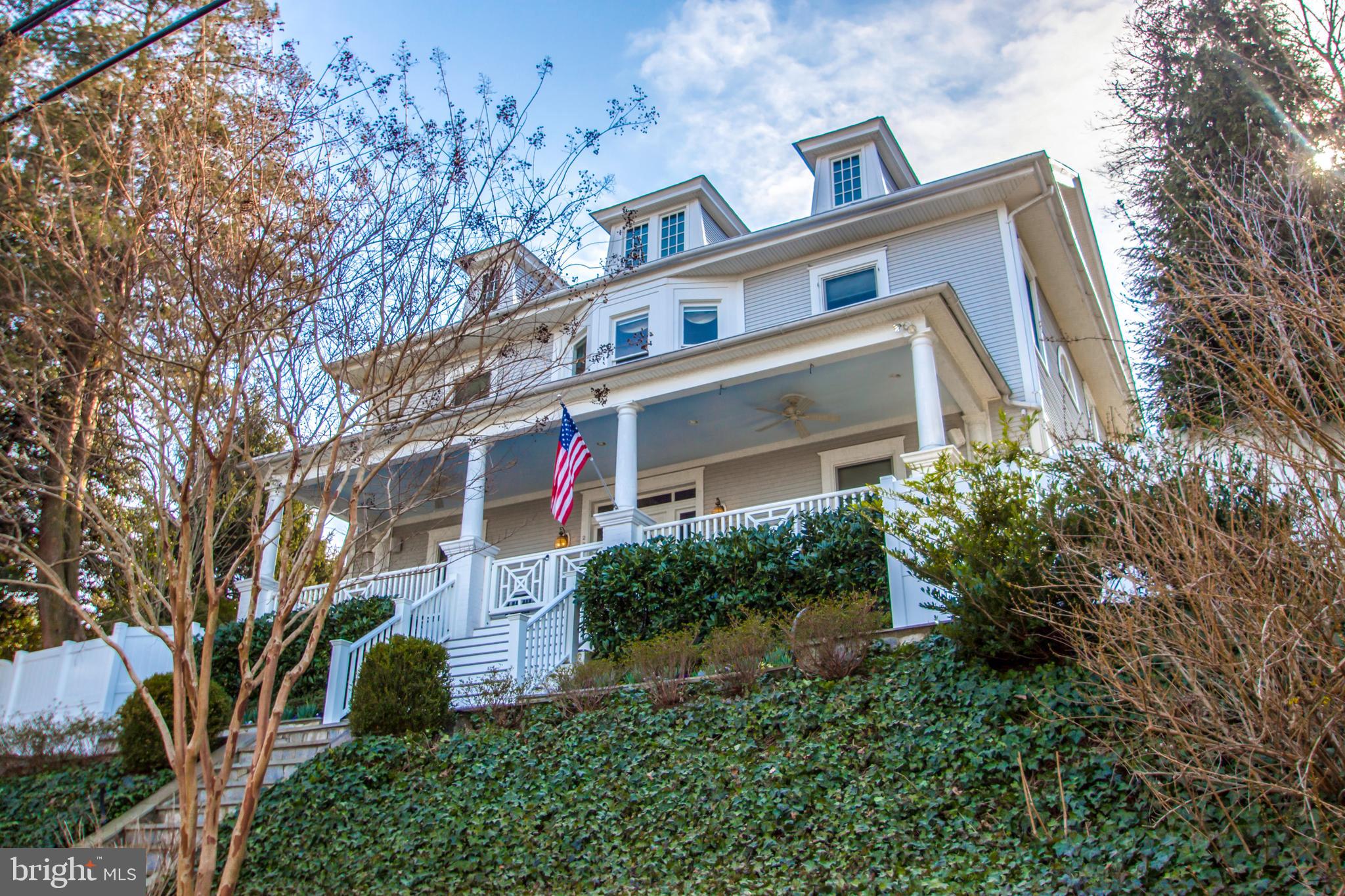 HUGE PRICE REDUCTION of $200k!!! Graciously sited high on a hill, this classic 1910 colonial offers spectacular panoramic views of Alexandria, as well as the Capitol, the Washington Monument and the Potomac River! In pristine condition, this stately home has been lovingly and meticulously restored by its current owners with $800,000 in recent improvements. Perfect for gracious entertaining and comfortable family living, this four bedroom plus three and a half bath home boasts a huge 42’ x 8’ front porch, a grand entrance hallway with exquisite archways, embassy size rooms with ten foot ceilings and detailed moldings, plus a delightful sleeping porch. Many additional special features including pocket doors, a warm and inviting library with gas fireplace and built-in bookshelves, gourmet kitchen with center island and granite counters, plus adjoining sunny breakfast room. The second floor boasts a grand hallway with lovely archway, fine moldings, built-in bookcases and a fabulous sitting area with beautiful bowed window. The third floor features a huge 40’ x 25’ bedroom with charming window seats, skylights plus full bathroom. The lower level includes a game room, exercise room or home office. Abundant storage is provided in the spacious utility room. The large beautifully landscaped garden is perfect for summer entertaining on the spacious elliptical stone patio with plentiful seating for guests on the stone walls. And there is loads of play space for children! Easy parking in the two car garage, plus two additional off-street parking spaces. Just a short walk to the King Street Metro, as well as Old Town’s finest shops and restaurants! This gracious and elegant home is truly one of Alexandria’s finest! It offers the perfect blend of the charm of yesteryear with all of today’s modern conveniences! SUPER EASY ACCESS FROM THE REAR OF THE HOME!!! From King Street Metro, West on King Street, Left on Upland Place, Left into first alley on the left. Drive to the end of alley and park in front of the two car garage at very end.