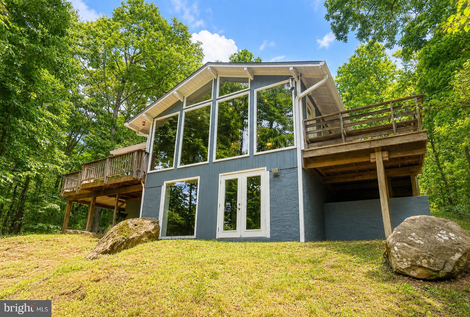 This charming 4-bedroom, 3 full bath home is tucked just off Freezeland Road, nestled among the trees and within walking distance of the Appalachian Trail and access to the G.R. Thompson Wildlife Management Area — outdoor lovers, take note!

Freshly painted throughout, this inviting home features brand-new LVP flooring (2026), expansive windows with lush green views, and an abundance of natural light. Recent updates include a new roof, washer & dryer, refrigerator, and stove (2024), offering both style and peace of mind.

Enjoy cozy winters with the high-quality wood-burning stove that helps save on heating costs, propane heat, and the convenience of a tankless hot water heater. Step outside to the large deck where you can hear a pin drop while relaxing with your morning coffee surrounded by nature. The property also features a fire pit and a large auxiliary driveway with VDOT state-maintained road access.

Located in the Blue Mountain community, residents enjoy nearby lake and beach access perfect for fishing, relaxing, or simply soaking in the peaceful mountain setting.

The sale includes both the .89-acre homesite and the adjoining .79-acre parcel for a combined 1.68 acres of wooded privacy and possibility! ***See Survey in attached Documents***