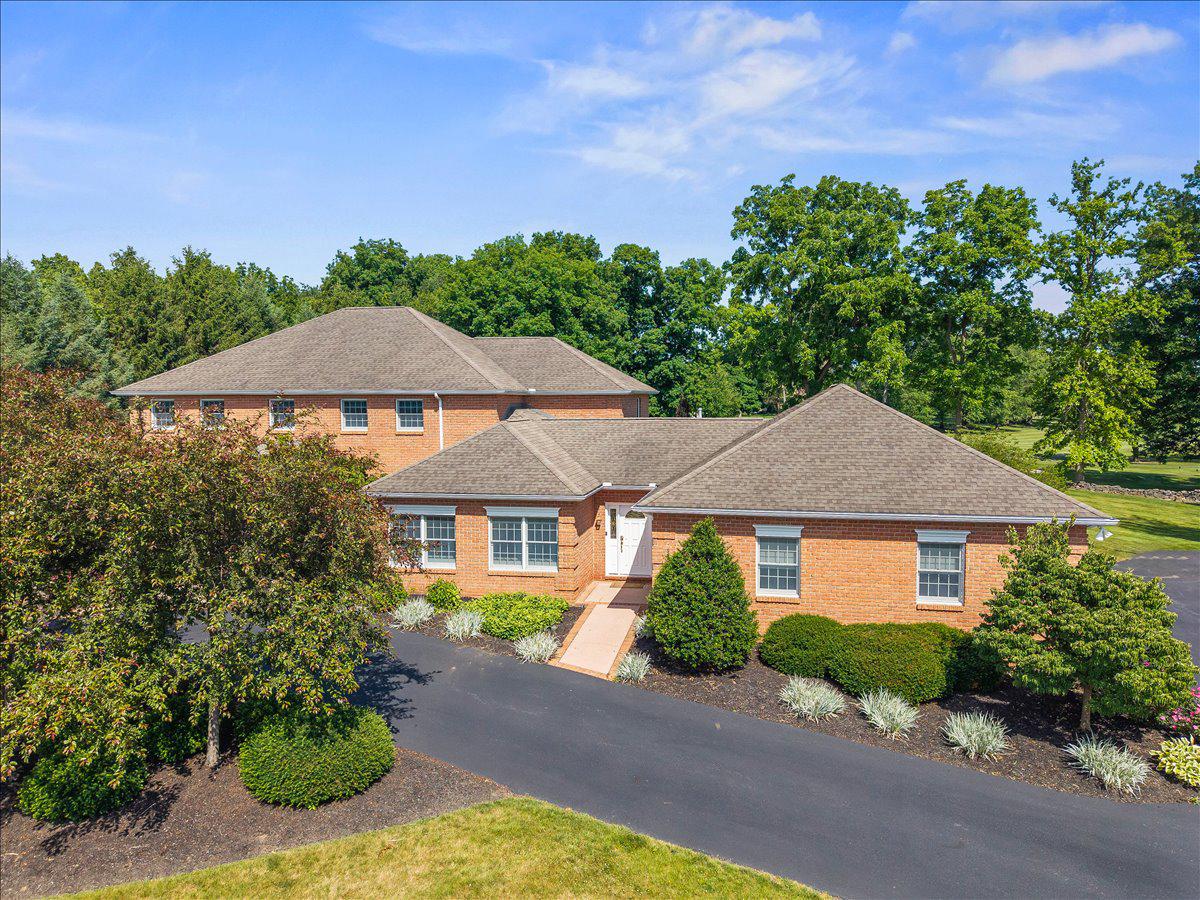 Luxury Golf-Course Living - This is a rare opportunity to live on one of only fourteen homesites that directly border the Lebanon Country Club golf course
Welcome to this stately, all-brick traditional estate offering 5,420 square feet of meticulously designed living space, situated on a premier 1.00-acre lot in North Cornwall Township. Perfectly positioned adjacent to the scenic 3rd green at the Lebanon Country Club, this property delivers a resort-style lifestyle paired with exceptional privacy. 

Grand Living Spaces & Sophisticated Amenities
A striking circular driveway guides you to the formal double-door foyer entry, welcoming guests with immediate views of the home's detailed craftsmanship. The expansive main level is engineered for both daily living and large-scale hosting, featuring a grand dining room and a warm family room anchored by a cozy gas fireplace and a built-in wet bar with an integrated wine rack. The heart of the home is the classic cherry kitchen, fully equipped with timeless tile flooring, a functional double sink, and a walk-in pantry. The home also has a Generac 20Kw generator.

Dedicated Office, Library & Creative Studio
Perfect for remote professional work or artistic pursuits, this home boasts multiple dedicated office spaces. The magnificent private library features custom built-in shelving complete with a classic sliding library ladder. Nearby, a spacious art room/studio provides the ideal footprint and light from two skylights for creative projects or hobbies .

Main Floor Primary Sanctuary
The main floor primary suite is a private retreat highlighting a dramatic tray ceiling large enough to accommodate dual ceiling fans, custom built-ins, and an expansive walk-in closet. The attached primary bathroom offers an oasis experience with its deep jet-powered soaking tub, separate shower, dual sink vanity, dedicated beauty/grooming counter, and pristine tile flooring.

Upper Level Guest Quarters & Entertainment Balcony
The second level accommodates three generously sized bedrooms and two additional full bathrooms. A central upper-level common area features large glass display cases, a second wet bar for hosting convenience, and direct access to an outdoor balcony overlooking the pristine grounds, pool and view of the third green on the golf course.

Resort Backyard & Functional Basement
Step outside to your backyard oasis, featuring an inviting in-ground pool serviced directly by an accessible full bathroom located just inside the home's rear entrance. A spacious 3-car garage provides substantial vehicle storage and a main-floor laundry room features built-in cabinets, a utility sink, and a dedicated folding counter. The massive full basement provides optimal system reliability with two gas furnaces, a professional water treatment system, and boundless storage potential.

This home is not just a residence; it's a sanctuary that embodies the essence of luxury living. With its impeccable design, high-end features, and exclusive amenities, this property offers an unparalleled lifestyle that is both inviting and sophisticated. Experience the perfect blend of comfort and elegance in this remarkable home, where every detail has been thoughtfully curated for your enjoyment.
