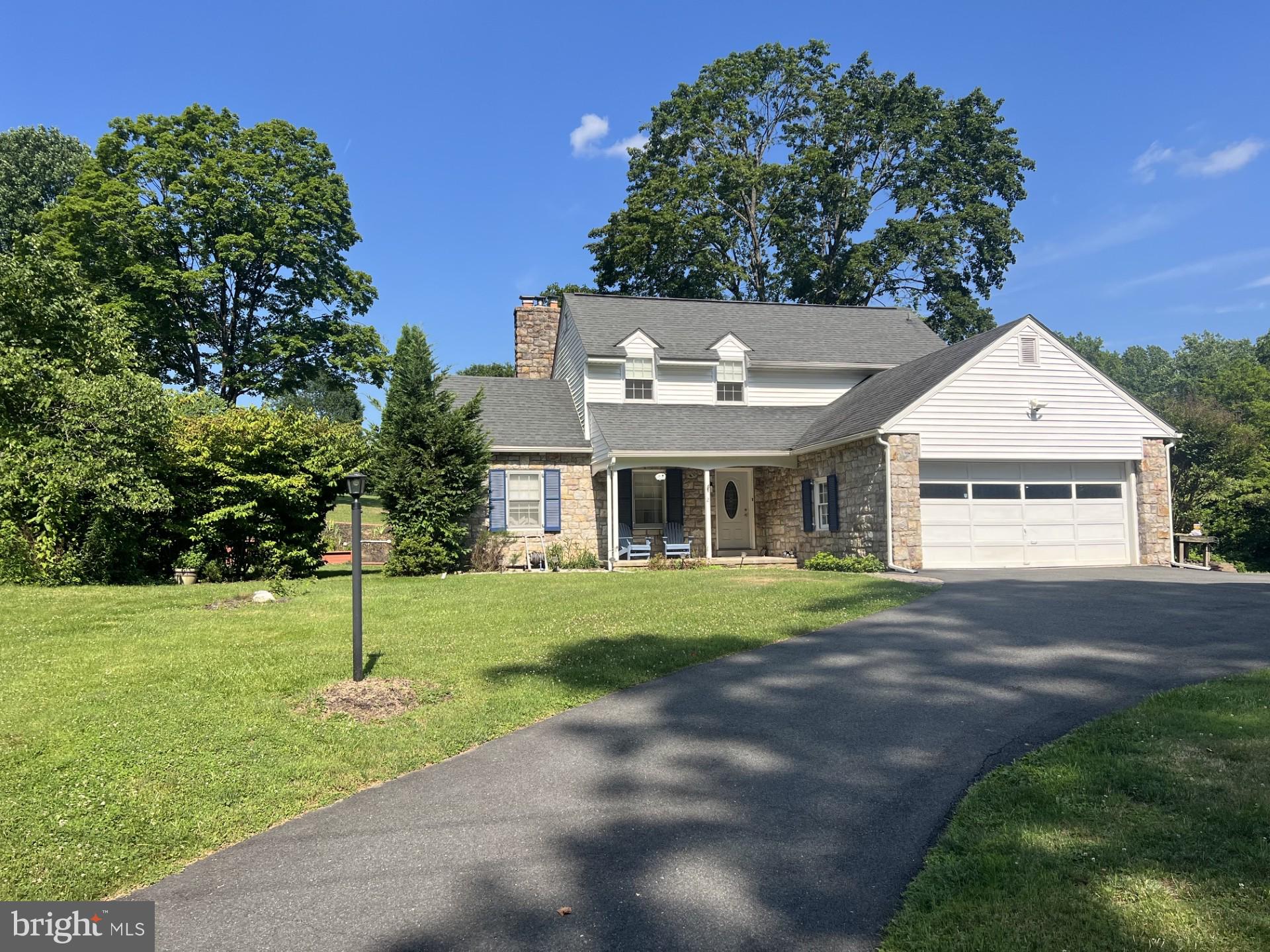 Welcome to this charming expanded stone Cape Cod, originally built in 1957, that beautifully blends timeless craftsmanship with comfortable everyday living. Situated on a picturesque 0.86-acre lot, this home showcases authentic stone construction, classic architectural character, and numerous desirable updates.
      The main level features beautiful oak hardwood floors, exposed wood beams, and an inviting oversized living room highlighted by a wood-burning stove insert, creating a warm and welcoming gathering space.                 The open-concept kitchen flows seamlessly into the dining area, offering an ideal layout for entertaining and everyday living. A flexible first-floor room provides the option for a home office, den, or potential third bedroom, adding versatility to the floor plan.
      Upstairs, you’ll find two exceptionally spacious bedrooms, a full bathroom, a cozy sitting area, and attractive softwood flooring that complements the home’s historic character.
      The finished lower level expands the living space with a built-in wet bar, making it an excellent area for recreation or entertaining. Additional features include a two-car garage with 240-volt electrical service, ideal for workshop equipment, electric vehicle charging, or hobbyists.
      Outdoor living is equally impressive, featuring a private backyard setting with a beautiful outdoor entertaining area complete with a stone fireplace, all surrounded by the mature landscape of the nearly one-acre lot.
      This home’s authentic stone exterior, exposed beams, hardwood flooring, flexible living spaces, finished basement, and picturesque setting combine to create a property with enduring appeal and significant market value.