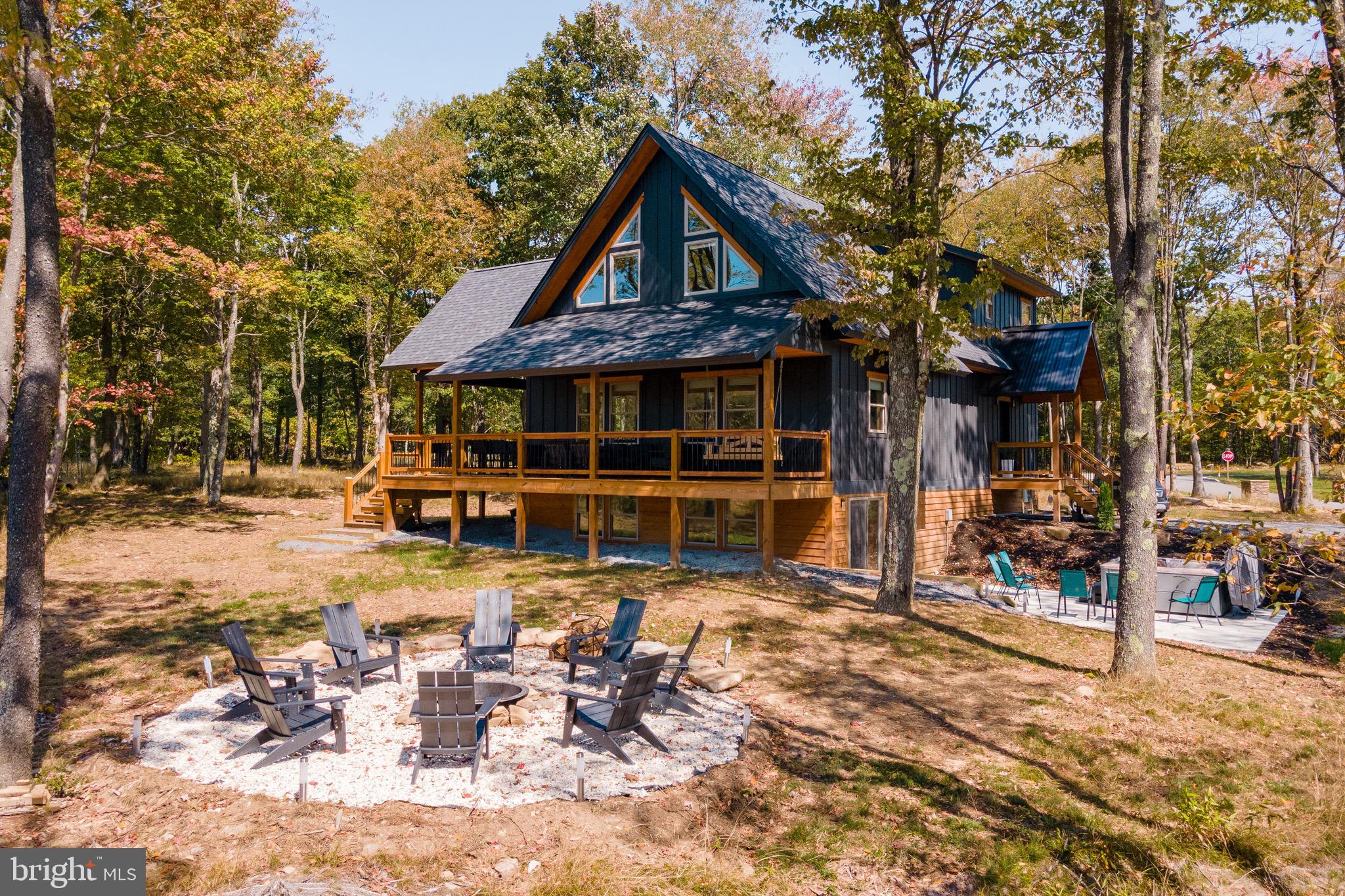 Welcome to All The Time, a beautifully crafted mountain retreat in the heart of Deep Creek Lake and right along Lodestone Golf Course. Blending modern comfort with rustic charm, this inviting getaway is designed for unforgettable moments with family and friends. Inside, the bright open-concept living area features a cozy fireplace and plenty of space to gather after a day of adventure. The fully equipped kitchen and spacious dining area make entertaining effortless, while the expansive deck invites you to dine outdoors, sip morning coffee, or unwind in the fresh mountain air. End your evenings around the fire pit or relax in the hot tub under the stars. Just minutes from the lake, golf courses, hiking trails, and local favorites, Fishing/swimming access off of Marsh Hill Rd on Deep Creek Lake! All The Time offers the perfect mix of comfort, location, and mountain-lake magic. With its strong appeal as both a personal retreat and income-producing vacation rental, this home is ready to be enjoyed from day one. Whether you're seeking adventure, relaxation, or both, this Deep Creek escape delivers it all.
