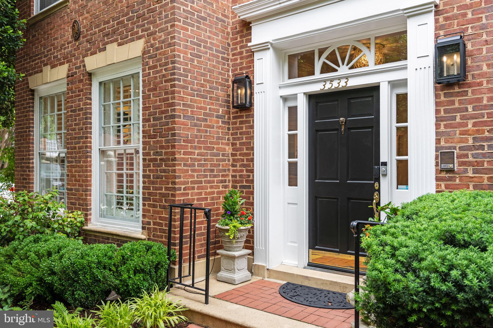 Beautifully renovated in Georgetown! 5-bedroom, 4.5-bathroom home offering over 4,200 square feet of exceptional living across four finished levels with rare two-car garage & elevator! Positioned on a desirable corner lot along Cherry Court, this quiet urban oasis delivers an exceptional sense of privacy, generous living spaces, soaring ceilings, beautifully landscaped outdoor areas, and an oversized two-car garage with additional parking flexibility.

One of the largest residences in the community, the home features elevator access to all four floors and has been extensively and thoughtfully renovated throughout. The transformation is perhaps most striking in the kitchen, now the true heart of the home. This light-filled space flows seamlessly into the dining room and showcases a Lacanche gas range, an oversized island with abundant counter space, and an additional doorway connecting to the living area — creating ideal flow for entertaining. The living room impresses with custom bookshelves flanking a wood-burning fireplace, elegant custom molding, and rich hardwood flooring.

The primary suite, which encompasses an entire floor, has been reimagined to include a beautifully crafted dual office with custom cabinetry and separate workspaces, a private sitting room, and a spa-inspired bath featuring Poggenpohl cabinetry. The upper floor offers three additional bedrooms and two updated full bathrooms, along with a secondary laundry area. The fifth bedroom is located on the lower level, accompanied by a renovated full bathroom, a dedicated laundry center, gym area, and a spacious rec room.

Additional highlights include three wood-burning fireplaces, custom millwork and built-ins, recessed lighting, programmable landscape lighting, and an irrigation system. Significant system upgrades include a new roof (2020), updated HVAC, upgraded electrical infrastructure, and a security system. The oversized two-car garage is also equipped for simultaneous electric vehicle charging at both bays. With generous proportions, extensive improvements, an elevator serving all four floors, and a prime Georgetown address within the coveted Donohoe-built section of the Cloisters, this is a rare opportunity to own one of the area's premier homes.