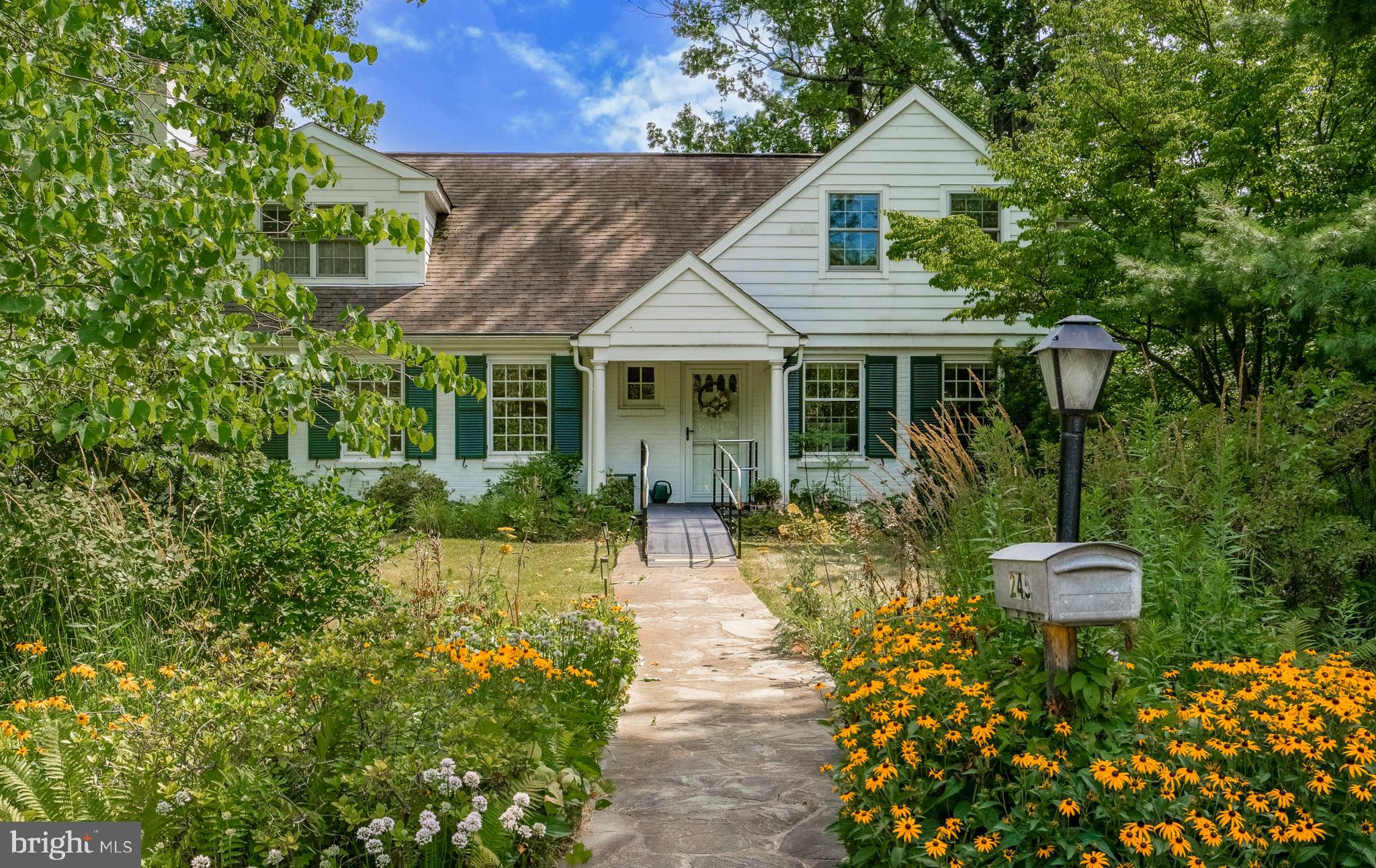 Like stepping into a fairytale, you can’t help but be swept away by the enchanting surroundings and serene landscape that 245 Broughton Ln. has to offer. Only steps from Villanova University, but so completely tucked away, that you’d have no idea a property like this could even exist in such a prime Main Line location. Enjoy reading a novel, laid out on your private dock along the bank of your private pond, while losing yourself in all that mother nature has to offer. Amongst the robust habitat of birds, bunnies, flowers, and the trees, there’s even a 2,500 sqft move-in ready, cape cod style home, complete with 4 bedrooms (including a large updated primary suite with walk-in closet AND a first floor bedroom) plus three full baths. Additionally, the home has an expansive walk-out lower level that takes you right to the oversized two-car detached garage. While you may have modern updates (open kitchen with granite island, stainless appliances, and shaker-style cabinetry), walls of windows, and hardwood throughout, the simple joy of a warm brick fireplace and views of your private backyard ‘nature preserve’ will leave you calm and recharged. Located in award-winning Lower Merion School District, walking distance to Villanova University, and mere minutes from shops, restaurants, and public transport, this home checks all the boxes.