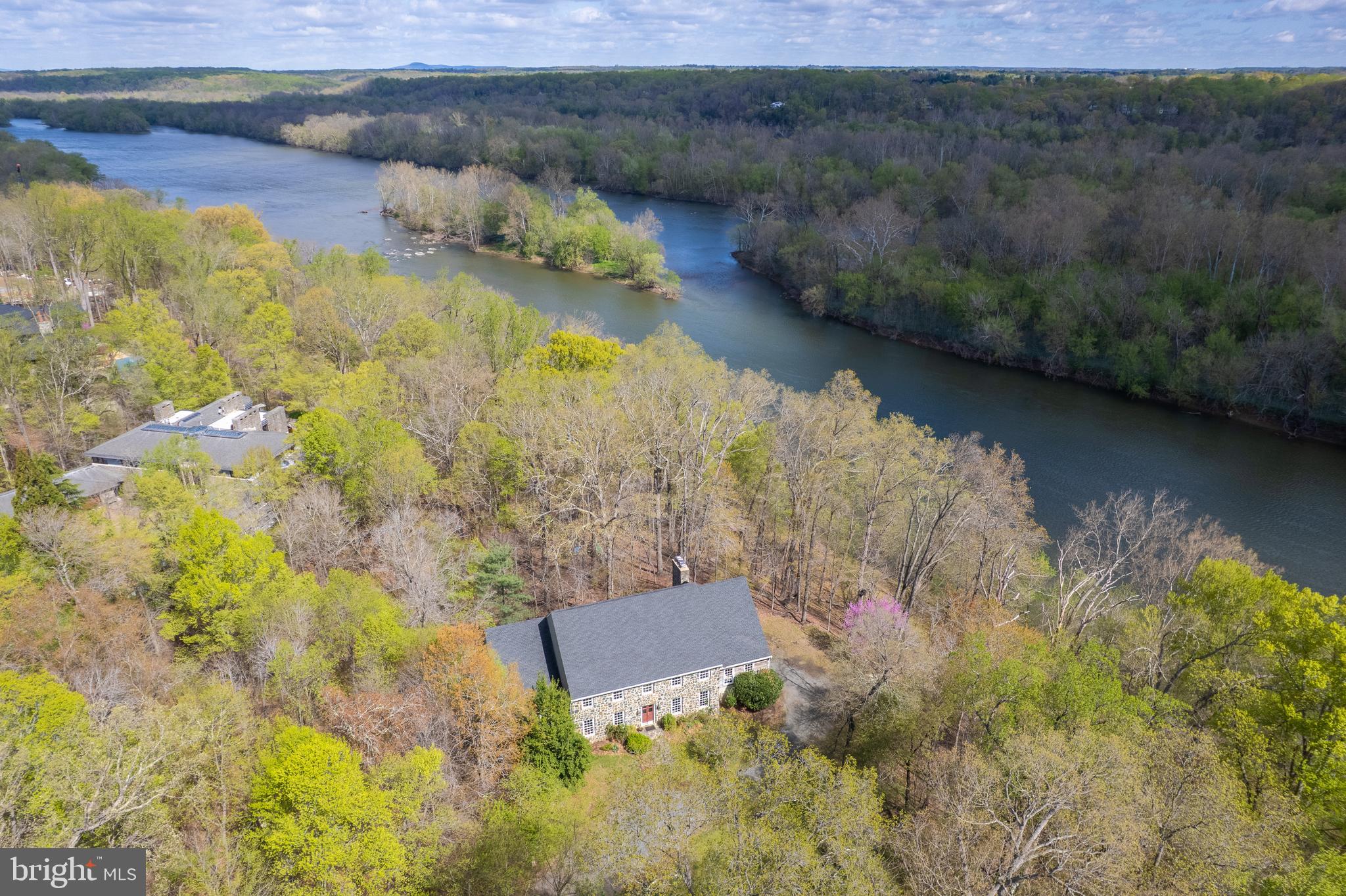 FABULOUS NEW PRICE!!!!  BUILD YOUR DREAMHOME OR RENOVATE
An extraordinary opportunity to own a premier 3.12-acre estate with over 200 feet of private direct Potomac River access.  This home offers a rare combination of privacy, natural beauty, and endless waterfront enjoyment. Nestled in the heart of Great Falls, this exceptional property provides breathtaking, year-round river views and a direct connection to nature, perfect for kayaking, canoeing, or simply taking in the serene surroundings.
At over 8,100 square feet, this custom Pennsylvania Bluestone home, built in 1988, is ready for transformation, offering limitless possibilities to create a showstopping luxury retreat. Expansive rooms, soaring ceilings, and a thoughtfully designed layout maximize both space and light. The upper level features five bedrooms, including a grand primary suite with panoramic river views. The main level has a wing with additional bedrooms complete with ensuite bathrooms perfect for in law, au pair or potential additional office space.  A formal dining room, and a spectacular great room with a fireplace and a deck overlooking the water all are perfect for seamless indoor-outdoor living. The open-concept kitchen and family room, complete with a fireplace, provide a warm and inviting space for gatherings.
The lower level is designed for convenience and adventure, featuring a walkout to built-in river steps, a spacious bedroom, and ample storage, including dedicated space for kayaks. With its unrivaled setting and boundless potential, this estate is a rare gem, promising an unparalleled waterfront lifestyle just minutes from the heart of Great Falls.