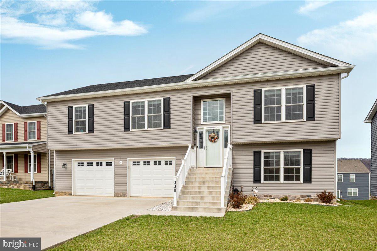 Welcome to this beautifully maintained home in the sought-after Red Hill subdivision in Martinsburg, WV, offering a perfect blend of comfort, space, and modern functionality.

<br><br>

The open-concept main level features a bright and airy living room that flows seamlessly into the kitchen and dining area, ideal for both everyday living and entertaining. The kitchen is well-appointed with ample cabinetry, granite countertops, stainless steel appliances, and a spacious island that provides additional seating and prep space.

<br><br>

Step outside to one of the home’s most impressive features, a stunning maintenance-free elevated deck designed for relaxation and entertaining. Complete with solar-capped railings that softly illuminate the space in the evening, this outdoor area offers both beauty and convenience. Enjoy spectacular mountain views from the upper-level deck, creating a peaceful backdrop for morning coffee or evening gatherings. Below, you’ll find a covered patio that provides additional outdoor living space, perfect for entertaining or unwinding.

<br><br>

The home offers generously sized bedrooms, including a comfortable primary suite, along with well-appointed bathrooms featuring modern finishes and a double vanity. The lower level provides additional living space that can serve as a recreation room, home office, or even a fourth bedroom, offering flexibility to suit your needs.

<br><br>

Car enthusiasts and hobbyists will appreciate the oversized two-car garage, offering ample room for larger vehicles or pickup trucks, along with plenty of additional space for storage, tools, or a workbench setup.

<br><br>

Situated in a desirable community with convenient access to local amenities, shopping, and commuter routes, this home combines thoughtful design with everyday practicality. Don’t miss your opportunity to own this exceptional property in Red Hill.