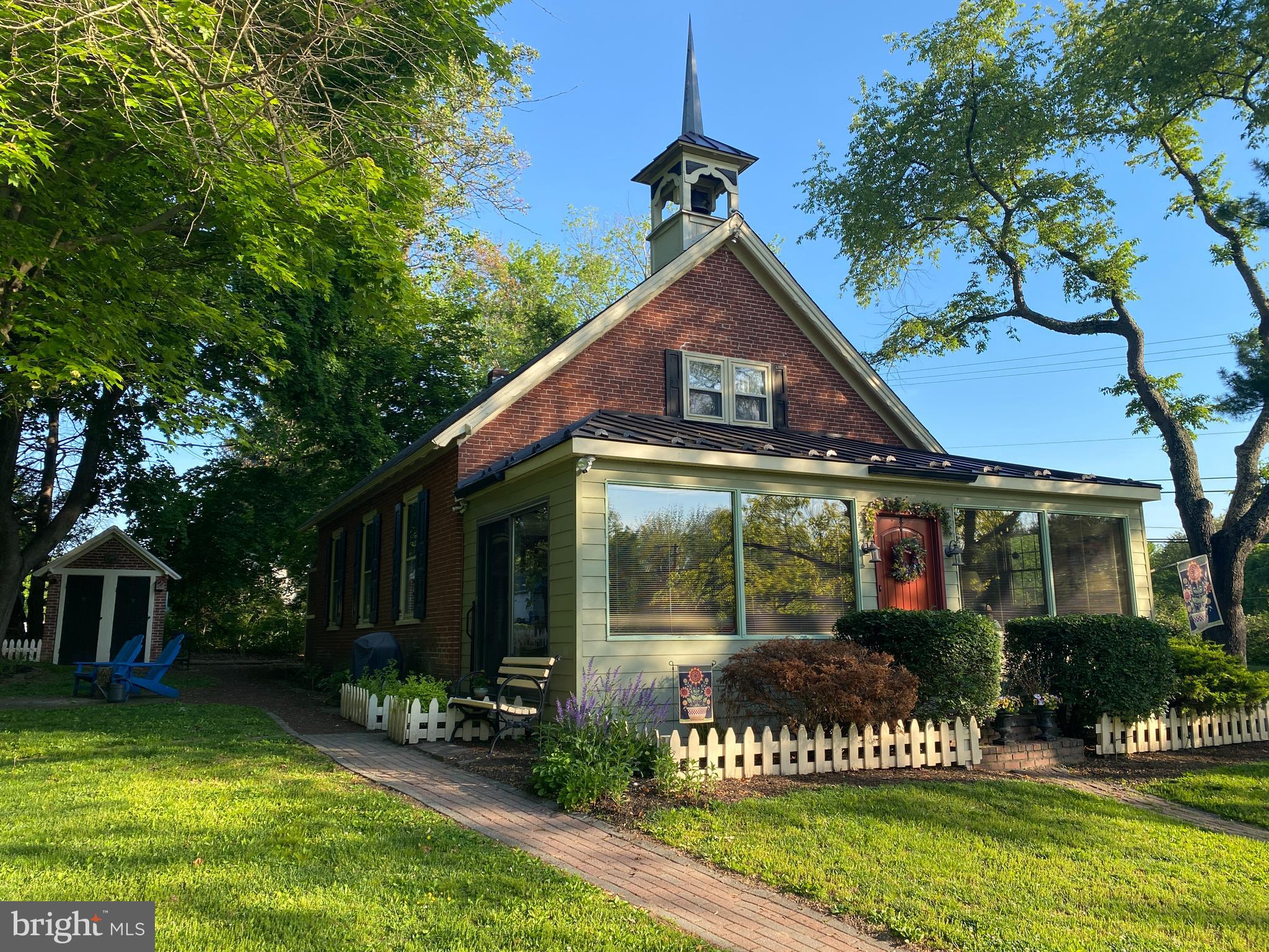 This “One of a Kind” former one room Schoolhouse formerly known as the "Red School" is now available  for your next home. It served as a school into the 1950’s, then remodeled into a home in the late 70’s. This 140+ year old structure has been responsibly maintained and improved over the last 40+ years. The owners have stated "It has a happy personality" and "We are always happy to come home"!
The Sunroom serves as the entrance and was the only addition to the original footprint. Visually, it
brings a lot of the outside inside. Morning exposure to southeastern sunshine warms the room in winter
and fall. From the Sunroom you pass through the former front door of the Schoolhouse into the Dining Room, which  is powerful. The high ceilings create a bigger than expected feeling about the interior. The downstairs rooms, Living Room, Dining Room and Kitchen all feature open beam 12 ft. ceilings. . These three rooms also feature the original and refinished diagonal maple wood flooring. The Living Room includes part of the original teachers' platform as well as the original wall to wall slate blackboard with the name of the House Painter from 1886 above it. The wood stove offers a pleasant environment in the colder weather. The Dining Room is a large open area with easy access to the whole downstairs. It features a wooden cover of the former access panel of the belfry rope, also with initials of the painter. The Kitchen contains a dish washer, deep sink, Corian countertops, electric range/oven, refrigerator, and large cabinets on three walls.
The Bathroom has a built in bathtub and shower with Moravian deco tile outlining. It features a
homemade built-in vanity with a raised and embedded sink and matching toilet. The bathroom
has an independent baseboard heater with wall thermostat for warm bathing/showering. The Utility/Mudroom with backdoor access includes a washer, dryer and a fold away ironing board. It also has the other half of the teachers platform and a trap door in the platform with access to the crawl space. Deep shelving for storage was added to the room and a sturdy workbench for projects adds convenience. 
The 2nd floor is accessed by a stairway that is located between the Dining Room and Living
Room. The Powder room, is located at the top of the stairway. An opening in one wall
of that room is filled with a stained glass window that is seen from the first floor.  The Master Bedroom has a front wall that includes a double window that looks out over the front lawn. It also has eaves used for storage, and has access to the attic. The other two bedrooms also have deep set windows looking to the rear of the property, both with eaves access and one with a built-in closet and the other also access to the attic. The pine wood flooring on the second floor is beautifully finished.
The exterior of the House is surrounded by numerous flower beds and bushes. A Mister Landscaper sprinkling system waters the beds when needed. There is storage space for outdoor items in the large storage shed that has deep shelves and is large enough to park a lawn tractor. The former Two Seater Outhouse is now used as a gardening shed. 
This home is warm and inviting, and waiting for you to come and take a look. Make your Appointment today!