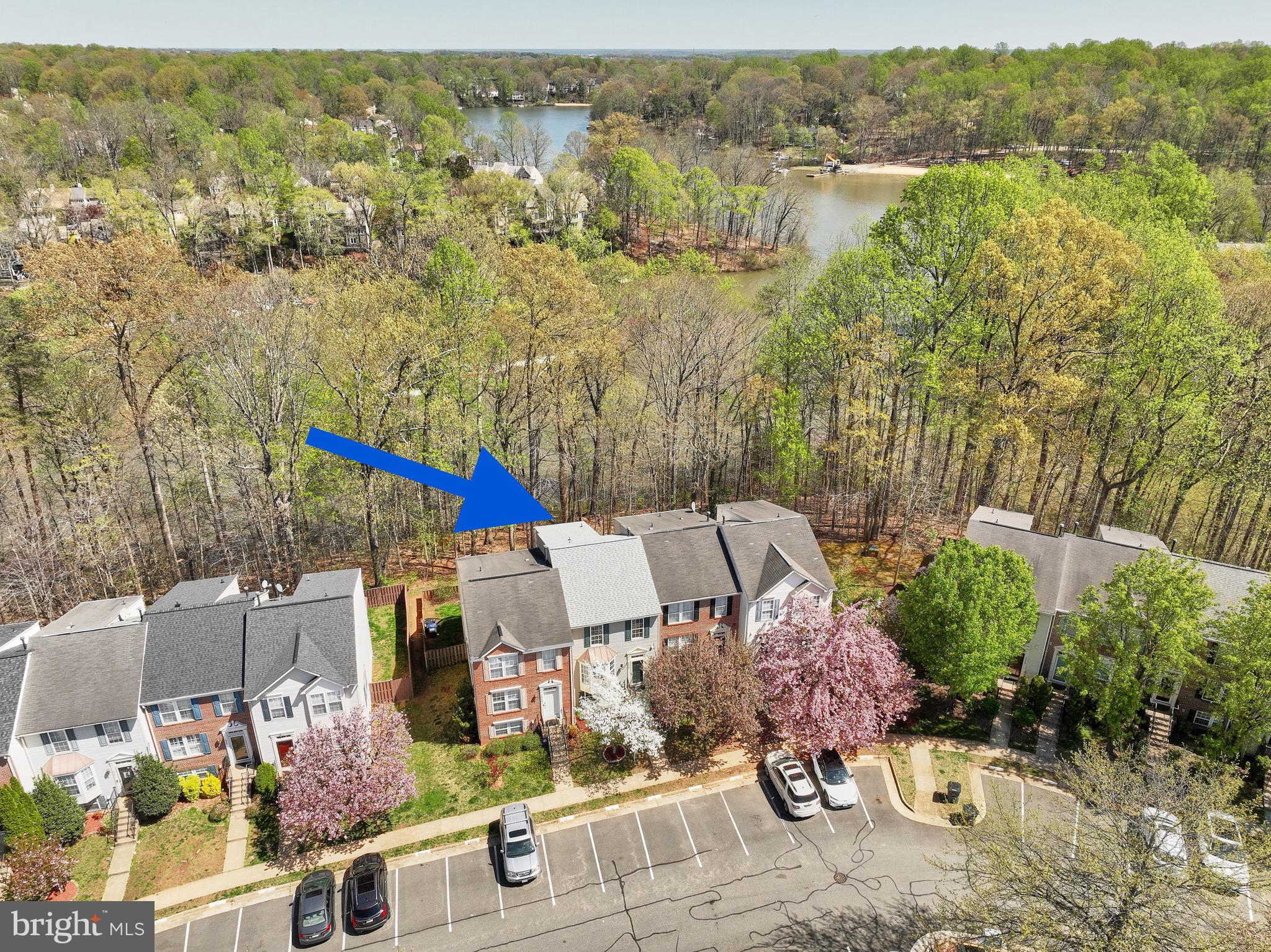 OPEN HOUSE CANCELLED. This home is under contract.   Is there anything better than lakeside living? Don't miss this RARE chance to live that lakeside life! The daily joy of  the lake view through the tranquil trees, taking a walk on the shoreline or going for a kayak ride. The deck optimizes your view while the lower level patio resides within the fully-fenced backyard. Life inside is just as breathtaking as the outside. Experience the luxury of s p a c e. This large townhome features a three-level bumpout affording a stunningly remodeled (March 2025) primary bathroom, a sunsplashed sunroom/breakfast room and a 4th bedroom with a fireplace. Another luxury? Knowing the major items of your home are less than 2 years old: Architectural grade shingles on the new roof, Trane HVAC and the gas hot water heater. All new in 2023!