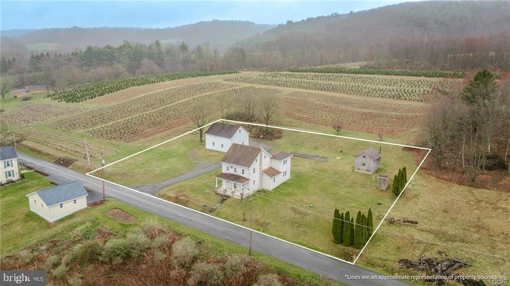 Discover the perfect blend of country charm and character in this delightful farmhouse, brimming with potential.  Built in the late 1800's this 3-bedroom, 2 full bathroom house offers a warm inviting atmosphere ready to be transformed into your dream retreat.  Main floor offers large eat in kitchen with porcelain farmhouse sink, plenty of cabinet and countertop space.  Spacious open concept dining and living rooms with original wooden details, built ins and chunky wooden pillars.  Full bathroom with walk in shower and main floor laundry room are a bonus.  2nd floor provides 3 nice sized bedrooms, 2nd full bathroom in addition to a full sized walk up attic offering much potential for more finished living space or an abundance of storage.  Outdoors are spectacular with your covered front porch and panoramic views of the beautiful Mahoning Valley.  Oversized 3 car detached garage with 2nd floor, workspace and plenty of storage room.  Large utility shed for gardening, mower storage and even more workspace!  This home is ideal for those seeking a serene lifestyle with plenty of space to stretch out and enjoy the outdoors, while remaining close to major travel routes!  Call today for your private showing and make this your dreamhouse!  PUBLIC OPEN HOUSE SUNDAY APRIL 13TH 1-3 PM.