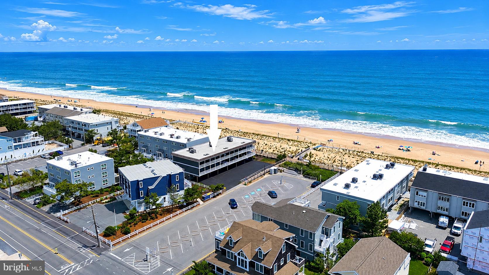 Rare opportunity to own an ocean block townhome just steps from the sand in the heart of downtown Bethany Beach. Situated adjacent to the Bethany Beach Boardwalk, this charming coastal retreat offers Atlantic Ocean views and an unbeatable location, with direct access to the beach just outside your door. Full of character and coastal charm, the interior features exposed beam ceilings and wide-plank walls, all painted crisp white to create a bright, airy atmosphere. Recent updates include luxury vinyl plank flooring throughout, brand-new stainless steel kitchen appliances, and a beautifully renovated bath featuring new cabinetry, a quartz vanity top, and a tiled walk-in shower. The light-filled living room opens to a screened porch where you can relax and enjoy ocean views and sea breezes. The primary bedroom also opens to its own private screened porch with ocean views, providing the perfect place to unwind. Offering 3 bedrooms, 1 full bath, and 2 half baths that could easily be converted to additional full bathrooms, this home comfortably accommodates family and guests. Offered fully furnished, this property is move-in ready and presents an excellent investment opportunity with a proven rental history. The ground-level screened patio provides secure storage, an outdoor shower, and easy access to a private boardwalk leading directly to the Bethany Beach Boardwalk and beach. Whether you're searching for a personal beach getaway, a year-round retreat, or a strong rental investment, this ocean block townhome offers the best of coastal living in an exceptional location just a short easy walk to all of the boutique shops and restaurants.