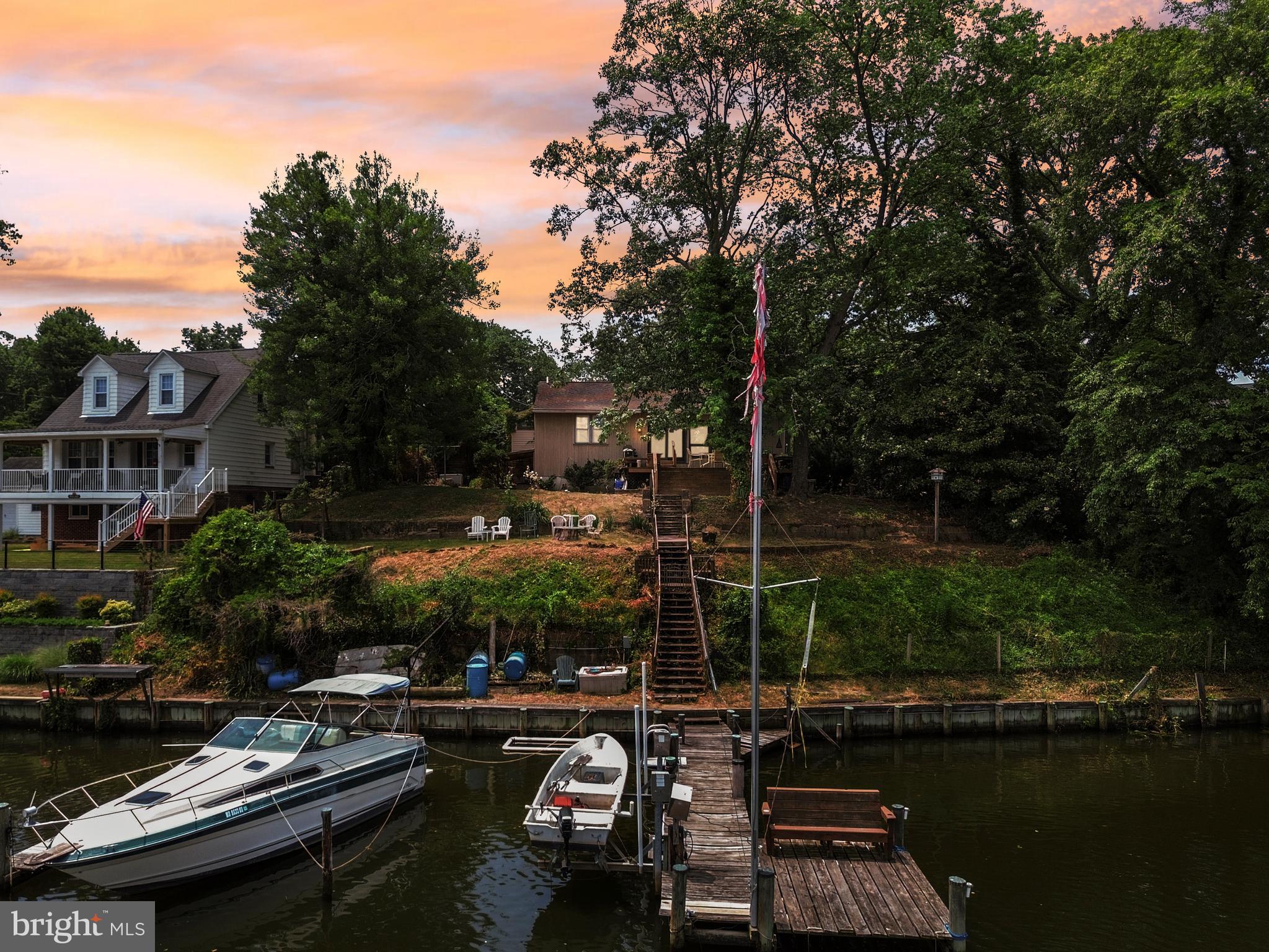 Nestled in the sought-after Laurel Acres community, this exceptional waterfront property offers stunning views and direct access to Nanny's Branch leading to the Magothy River. Elevated approximately 70 feet above the water, the home provides a unique vantage point and a peaceful setting surrounded by nature.

Inside, you'll find original hardwood floors throughout, a cozy propane fireplace, and a thoughtfully updated interior. The kitchen and both bathrooms were completely renovated in 2016, blending modern finishes with timeless appeal. A whole-house generator provides added peace of mind and convenience year-round.

Outdoor living is a highlight of this property. Relax on the inviting front porch, renovated within the last decade, or head down to the private pier featuring electric service, approximately 12 feet of water depth at the end, and a boat lift that conveys with the sale. Water enthusiasts will appreciate the opportunity to restore a third dock, with county approval and permits, potentially expanding the property's waterfront capabilities.

Whether you're looking for a primary residence or a waterfront retreat, 626 Laurel Drive offers an exceptional combination of updated living spaces, boating amenities, and breathtaking waterfront access in one of Pasadena's most desirable communities.