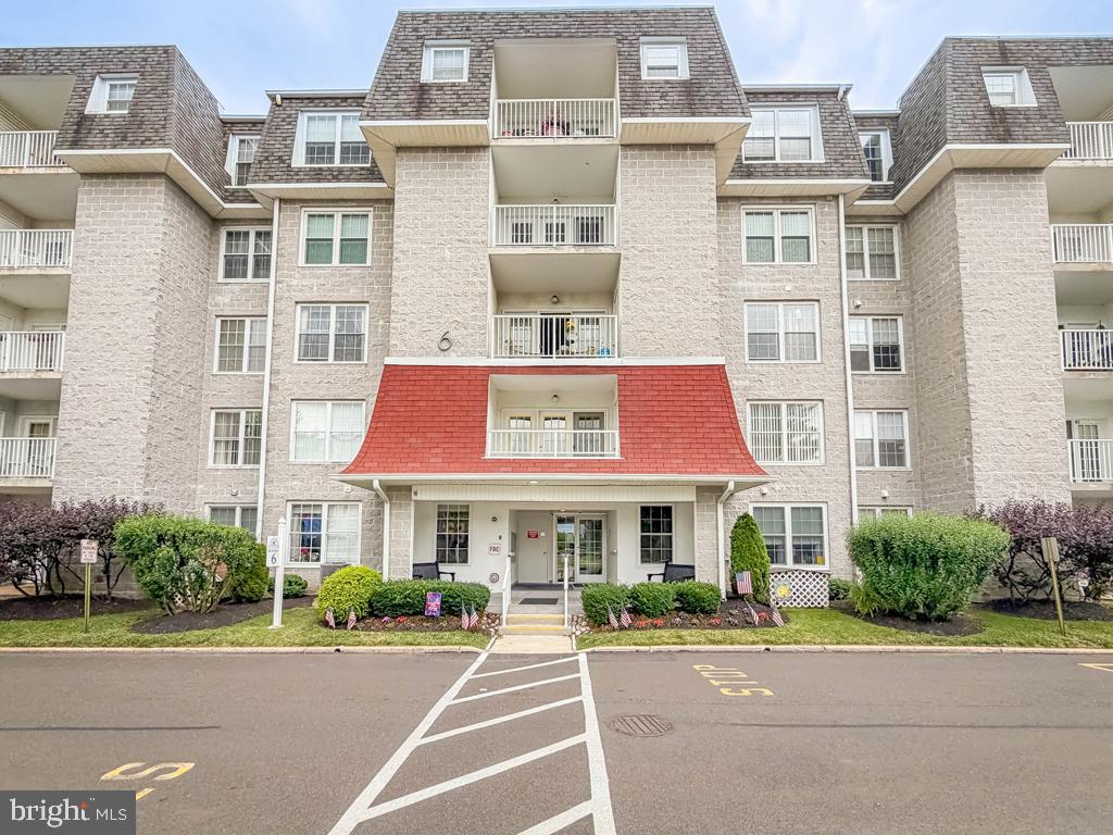 Welcome to Centennial Station, Bucks County's premier 55+ community offering an exceptional lifestyle and outstanding amenities. Situated on the second floor of Building 6, this spacious 1,584 square foot condominium offers 2 bedrooms, 2 baths, and a bright open floor plan designed for comfortable everyday living and entertaining. A welcoming foyer opens to an expansive living and dining area featuring neutral décor, recessed lighting, fresh paint throughout much of the home, and generous room sizes. French doors lead to a private covered balcony overlooking the beautifully maintained community grounds, creating the perfect space to enjoy your morning coffee or unwind at the end of the day. The updated kitchen boasts abundant white cabinetry, granite countertops, stainless steel appliances, a breakfast area, and a convenient pass-through to the main living space, allowing for easy interaction with family and guests. The generously sized primary suite offers ample room for a sitting area, a large walk-in closet with organizers, and a private bath with oversized stall shower. A spacious second bedroom is serviced by a full hall bath with integrated laundry area and provides flexibility for guests, a home office, or hobby room. Plentiful storage, elevator access, a secure building entrance, and convenient parking add to the appeal. Move-in ready and meticulously maintained, this home offers the perfect blend of comfort, convenience, and carefree living. Residents of Centennial Station enjoy a maintenance-free lifestyle with a beautifully appointed clubhouse featuring an indoor heated pool, fitness center, library, card rooms, billiards, meeting rooms, walking paths, shuttle service, and a full calendar of social activities, clubs, and events. Conveniently located near shopping, dining, major roadways, and SEPTA rail service, this is Bucks County active adult living at its finest.​ No dogs allowed.