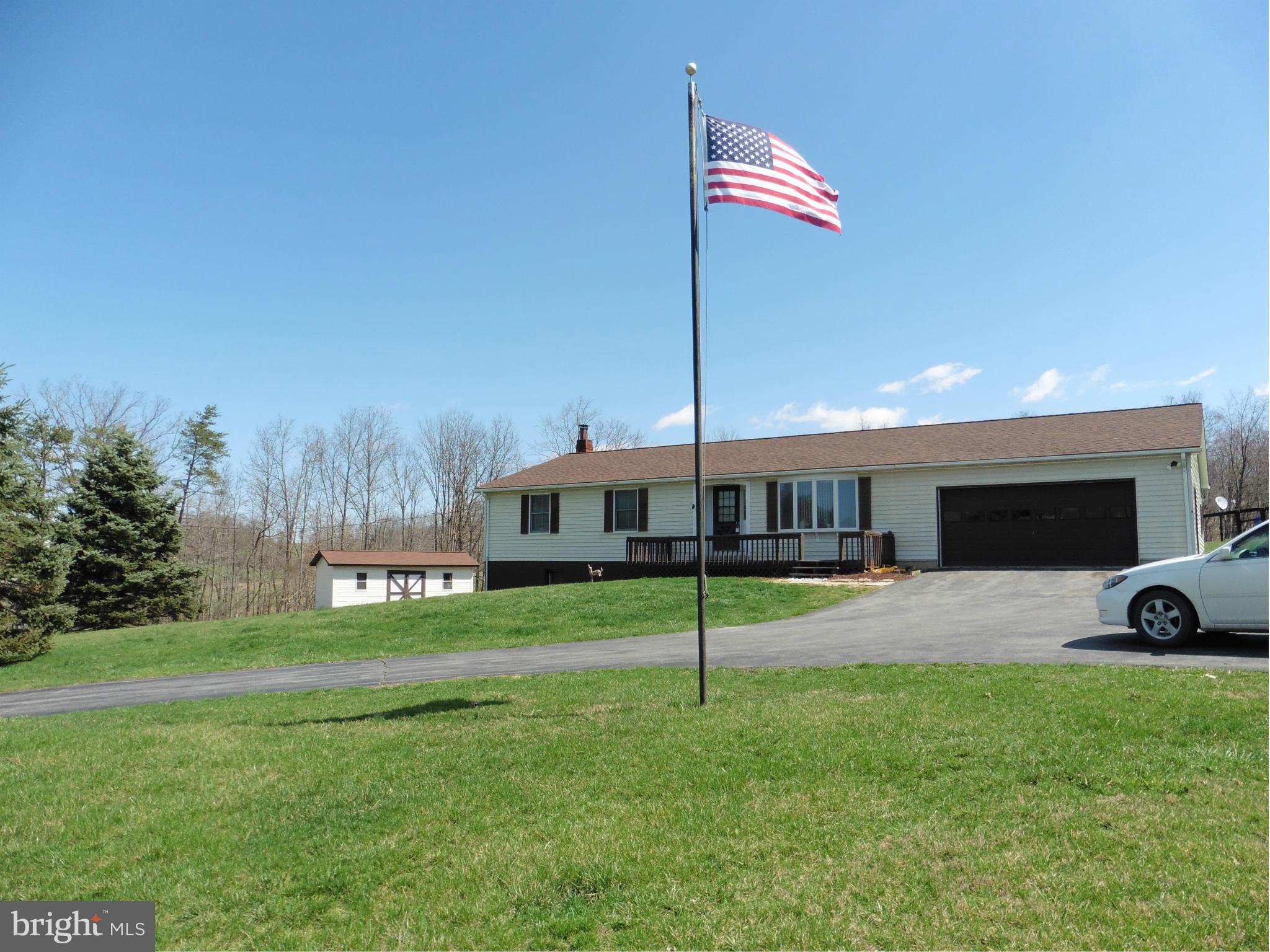 REDUCED $5K! Simple country living! Only 20 minutes to the stores and restaurants of WInchester City/Medical Center with gorgeous, mountain views year round. Live large with fenced paddocks, woods and a pond on 20 acres. Great one level living with recreation and storage in large basement, over sized garage, new carpeting, tile floors, and new roof. Seller will consider all offers. HOME WARRANTY!
