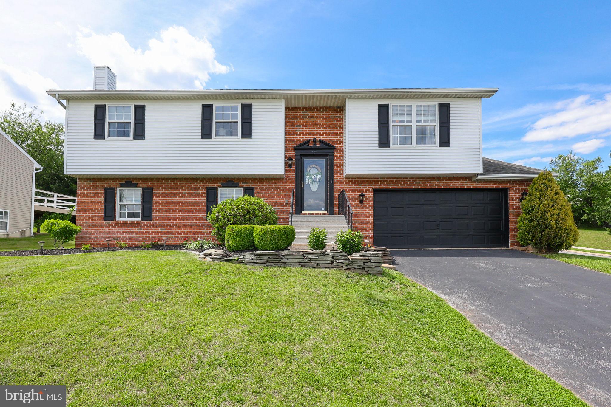 Nestled in a desirable Red Lion neighborhood, this beautifully updated bi-level home offers the perfect blend of modern comfort and inviting charm. From the moment you step inside, you’ll be greeted by vaulted ceilings, gleaming hardwood floors that flow throughout the main level, and a stunning skylight that fills the living space with natural light.

The main level features a bright and airy living room that seamlessly connects to a spacious dining area and an updated kitchen, complete with granite countertops, stainless steel appliances, and abundant pantry storage—ideal for everyday meals and entertaining alike.

Three generously sized bedrooms include a luxurious primary suite with a walk-in closet and private bath. An additional full bath with updated vanity and fixtures completes this level.

The lower level expands your living space with a huge family room featuring updated flooring, a cozy gas fireplace, plus a wood stove for supplemental heat. A convenient half bath and kitchenette make this area perfect for poolside entertaining, guest overflow, or game-day gatherings. Walk out to daylight and step right into your backyard oasis.

Outdoor living shines here: enjoy the elevated rear deck leading down to the pool deck, where a retractable awning and the covered deck above provide cool, shaded comfort. Host summer parties at your very own tiki bar, then cool off in the gorgeous in-ground pool—featuring a brand new liner for years of worry-free enjoyment. The privacy-fenced backyard offers plenty of grassy space to spread out, plus a small fire pit for evenings under the stars.

Additional highlights include an oversized 2-car garage offering ample room for vehicles, tools, and toys, plus a garden shed providing even more storage for outdoor equipment, seasonal items, or pool supplies.