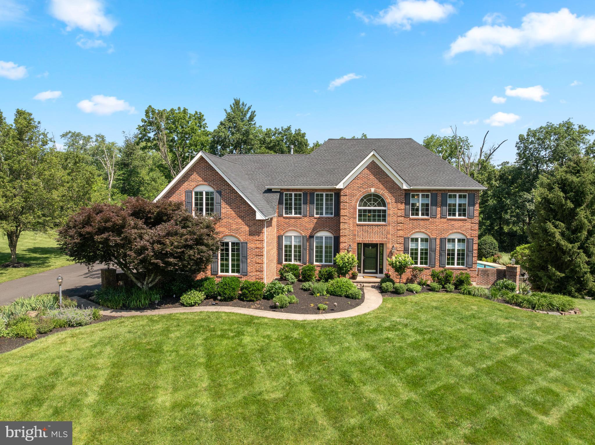 Elegant brick Colonial on 1.84 acres in sought-after Souderton School District

Nestled at the end of a quiet cul-de-sac in one of Harleysville’s most desirable neighborhoods, 845 April Hill Way offers a rare opportunity to own a meticulously maintained brick colonial set on 1.84 lush acres.

From the moment you step into the grand two-story foyer, you’ll be captivated by the home’s timeless elegance and thoughtful design. The main level features a private home office, a formal sitting room, and a gracious dining room ideal for hosting gatherings. The expansive kitchen is a chef’s dream, complete with granite countertops, a gas cooktop, a center island with seating and additional storage, a walk-in pantry, built-in recipe desk, and a sunny breakfast room. The heart of the home is the stunning two-story great room, anchored by a floor-to-ceiling wood-burning fireplace that creates a warm and inviting atmosphere.

Conveniently located off the kitchen is a spacious mudroom/laundry area with a utility sink and direct access to the oversized three-car garage.

Upstairs, the luxurious primary suite impresses with vaulted ceilings, a large walk-in closet, a secondary closet, and a spa-like en suite bath featuring a soaking tub and separate shower. The second bedroom includes its own private en suite bath, while the third and fourth bedrooms share a well-appointed Jack-and-Jill bathroom.

With over 3,600 square feet of above-grade living space and an additional 1,100 square feet of finished basement, this home offers exceptional versatility. The basement is designed for both relaxation and entertainment, featuring a playroom, a comfortable living area, a full bathroom, a wet bar, and ample storage.

Step outside to experience a backyard oasis designed for entertaining. The expansive outdoor living area includes a full kitchen with a gas grill, sink, built-in mini fridge, and storage, as well as a cozy seating area with a gas fireplace, mounted outdoor TV, pergola, and retractable awning. The in-ground swimming pool is surrounded by mature, professionally landscaped grounds that provide beauty and privacy.

Pride of ownership shines throughout, with over two decades of thoughtful upgrades and maintenance, including:

2004 – In-ground swimming pool installation

2004 – Outdoor patio and living area addition

2006 – Hardwood flooring throughout main and second floors

2007 – Finished basement with full bathroom and wet bar

2008 – Primary bathroom renovation

2017 – HVAC system replacement (single-unit)

2019 – New garage doors

2024 – Driveway resurfacing

2025 – Total roof reshingling

2025 – New rear patio door

2025 – Fresh paint throughout main and second floors

2025-  HVAC system replacement (second-unit)

This is a rare opportunity to own a turn-key estate home in an established community with easy access to local amenities, shopping, dining, and major routes. Schedule your private showing today and experience the exceptional lifestyle that awaits at 845 April Hill Way.