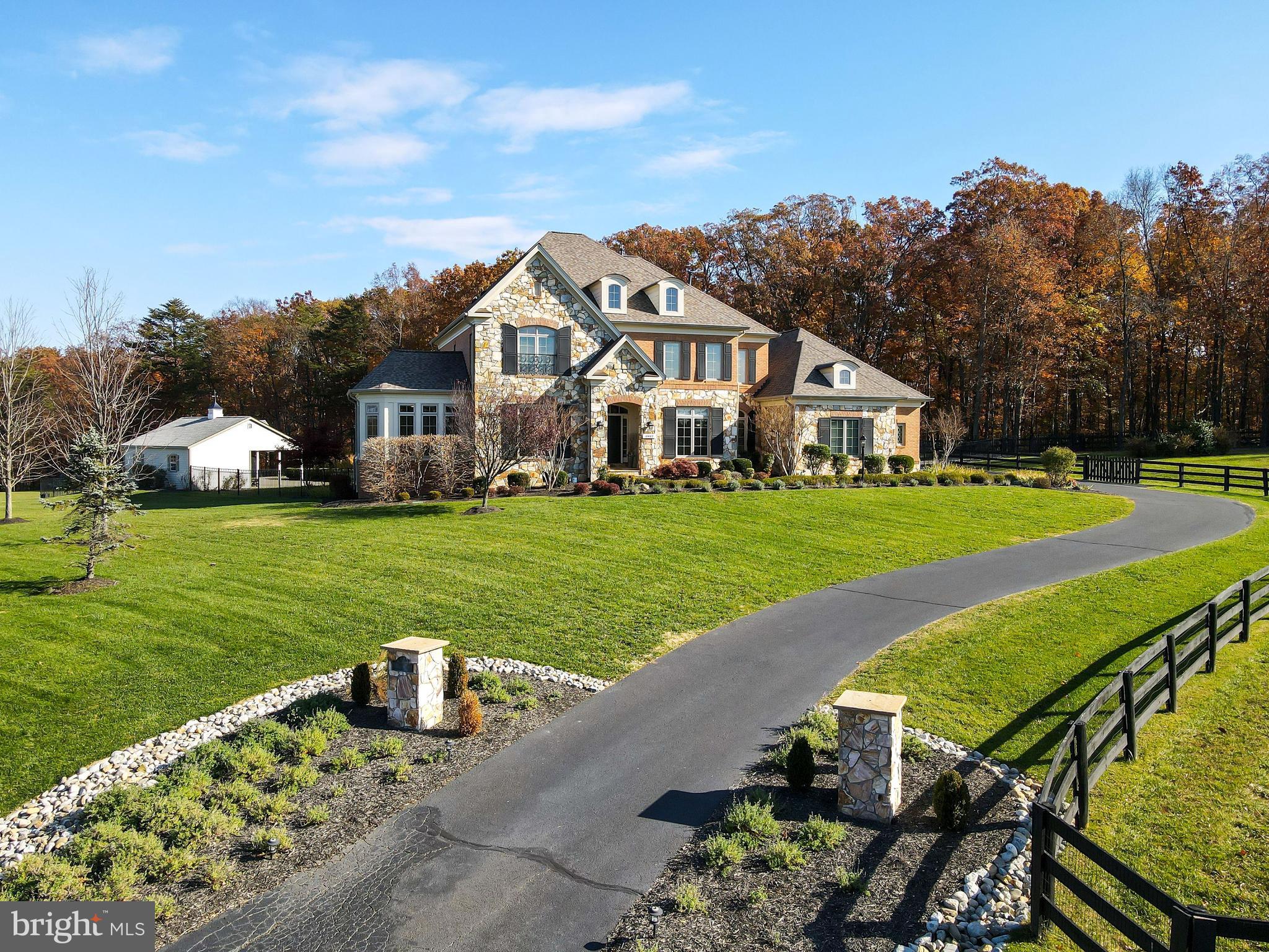 Just minutes from Downtown Leesburg, this gorgeous estate built by Basheer & Edgemore is nestled on almost 9 bucolic acres with a magnificent Pool, professionally landscaped grounds and breathtaking views of rolling meadows and mature trees. The impressive interior features a 2-story Foyer, Living Room that opens to the Sun Room. Dining Room with bay window that provides access to the Butler’s Pantry that has a warming drawer, wine fridge and walk-in Pantry. The bright Gourmet Kitchen is complete with granite counter tops, tile backsplash, pendant lights, hearth room with a gas fireplace. The Breakfast Room has a bay window with French door that opens to the Trex Deck and Patio. A cozy Family Room boasts coffered ceilings, arched entryways, built in shelves and a gas fireplace. To complete the Main Level is the Home Office, Elevator that stops on all 3 levels, Mud Room and Powder Room. The Upper Level features the expansive Owner’s Suite that has a Sitting Room, tray ceilings, built- in cabinets, two walk-in Closets and a luxurious spa bath with separate vanities, large soaking tub and glass enclosed dual shower. There are also 3 en-suite Bedrooms and a Laundry Room on the Upper Level. The Lower Level includes a spacious Recreation Room with a double sided fireplace, Wet Bar, Fitness Room, Bedroom and Bonus/Media Room. This estate is a commuter's dream with easy access to the Dulles Greenway, Dulles Airport, Rt7 and RT 15. (Verizon Fios installed)