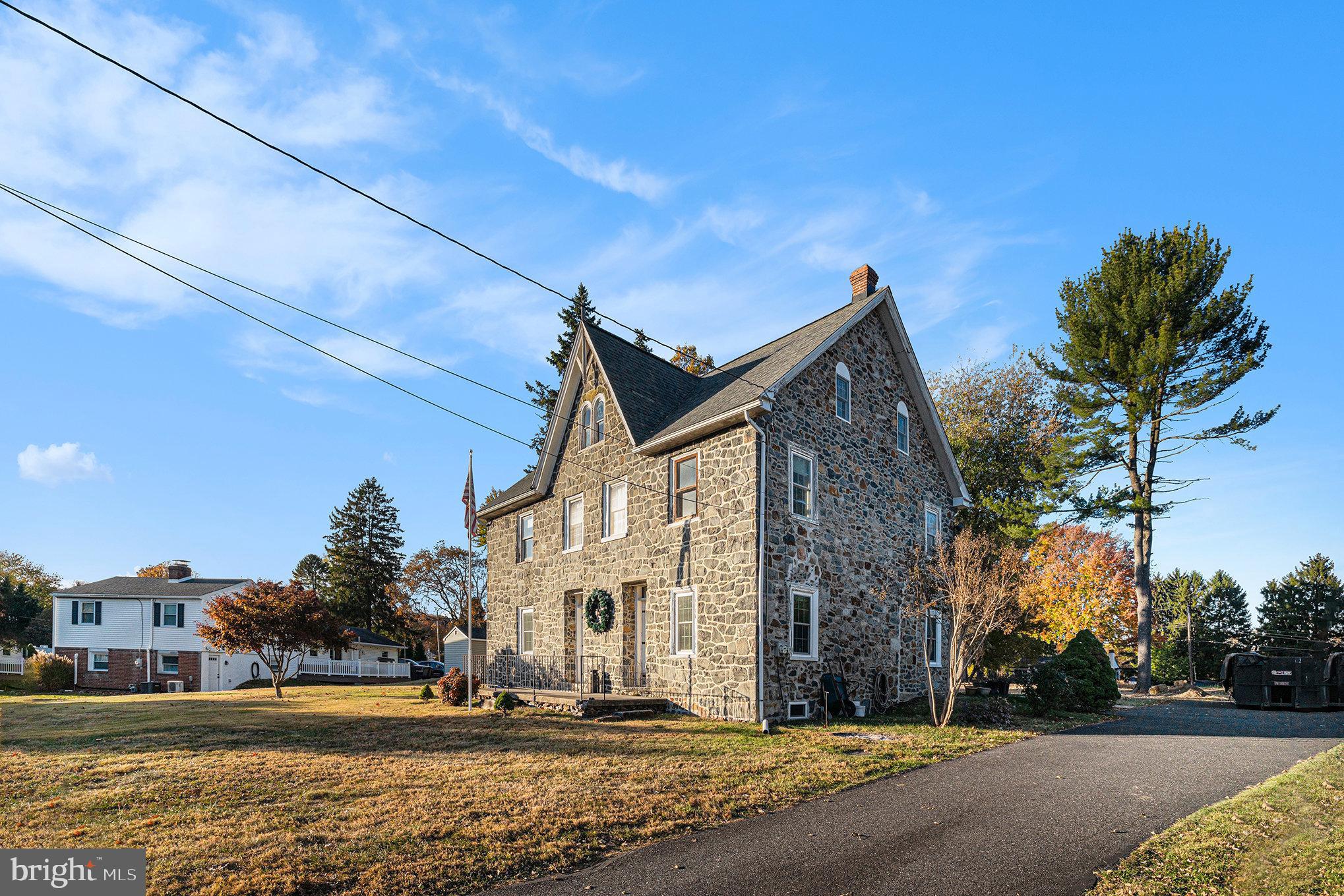 Welcome to Bethel Township’s historic roots– one of the original, unique homes that was built in 1827.  The beautiful stone facade of this home was made with the blue granite in addition to field stone that was collected around this lot and surrounding areas of Bethel. This center hall colonial used to be two homes that has since been made into one large home. The foyer divides the house down the center. On one side of the foyer, you will enter into the dining room that is open to the kitchen. Beams run from the front of the home to the back, original wide plank flooring run throughout, and in the dining room, you will find one of five fireplaces located within this home. In 1979, this kitchen was reconfigured, and cabinets were then replaced. On the other side of the foyer, you will enter the grand living room boasting original oak flooring, a stone fireplace, and what used to be one of the front doors. The foyer, located in the center of the home, includes a large coat closet, access to the basement, and a door leading to the back of the home (which is now the main point of entry). Up the large staircase and to the second floor, you will find a walk-in closet, 4 spacious bedrooms, 2 full bathrooms, 3 more fireplaces, and access to the attic via a spiral staircase which leads you to 4 additional rooms. The original doors are currently still intact and you will find other unique bits of character as you walk through this property. Outback you will find what was utilized as the “cold storage” for fruits and veggies, as well as an access point to where they used to smoke their meats. Now, this beautiful stone building could be utilized for storage with two separate entrances/levels. All windows have just been replaced in October and November of 2024. The water heater was recently installed on November 28th, 2024. In 2014 the roof was replaced. In 2004 the concrete was replaced around the back of the home leading you to the driveway. The property line is about 5 feet from the neighbor’s garage, there is a yellow marking on the driveway before the grass (towards the road), and it splits almost down the center of the grass to the street. The well is a about 25 foot deep with about 10 feet of water, hand dug and is stone stacked. There is a filtration system, and the well water has been tested frequently. Last test was completed about 2 years ago.  Home is currently being lived in but could use some repairs so priced to be sold in its current condition.

Set up your showing to see what you think about this little piece of history!