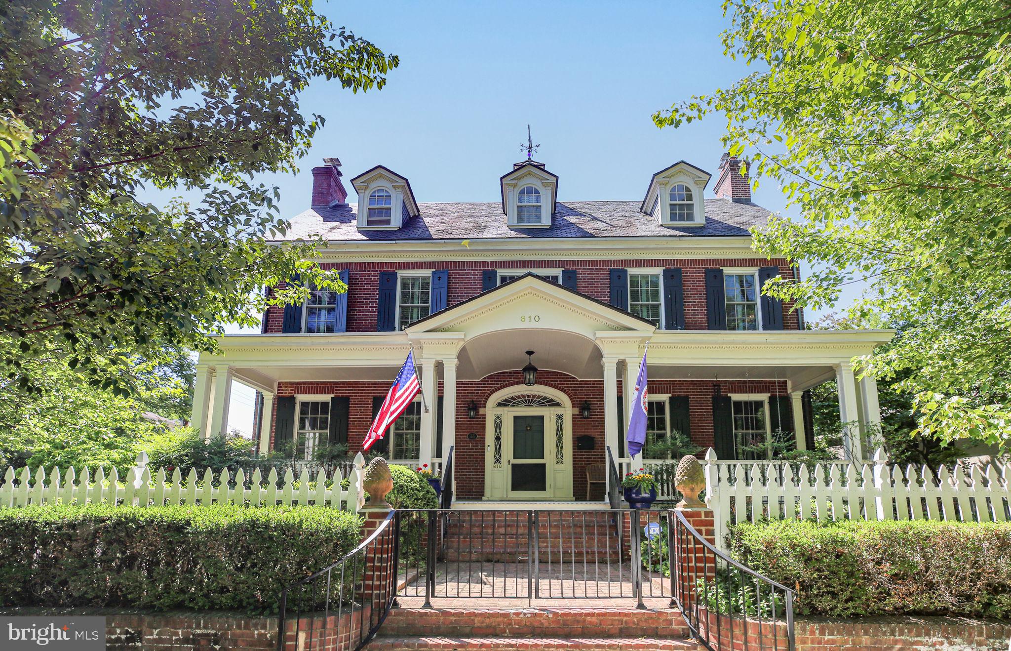 Gracious, historic home, on a corner lot in quiet neighborhood in the heart of downtown Fredericksburg. Welcoming front porch overlooks the gardens of Historic Kenmore. Details of fine craftsmanship are immediately evident in the woodwork and plaster mouldings. First floor features formal dining room, living room, kitchen, den with cherry paneling and built-in bookshelves; additionally, the garden room with tons of natural light has an eating area, bar, and opens to the patio and garden. Front and Rear staircases lead to the second floor. Over the garden room, the Primary bedroom has a vaulted ceiling, huge windows, balconies, walk-in closets, soaking tub, separate shower and heated floors in the primary bathroom. The second floor includes three more bedrooms (one with ensuite), hall bath, open sitting area, and a sewing or craft room. The completely finished Third floor has two large bedrooms, hall full bath and incredible storage. Other amenities include an Elevator, Off street parking, Slate and copper roofs, Radiators and radiant heat (Buderus boiler), and new HVAC with 9 zones throughout with multiple Mini splits. 

Built by Peck Heflin in 1928 with a major addition in 1997, and also numerous renovations in the last few years including all new Anderson windows on the first two floors of the original home, Mitsubishi split pack hvac on 3 floors, all new kitchen appliances and W/D,  new front hall closet, chimneys all reworked,  copper roof over the study,  plantation shutters throughout. The exterior has been upgraded with an irrigation system in the back garden, brick courtyard and upgraded driveway gate, bluestone patio flooring, white picket fencing, brick pillars, steel gate and railings, brick walls and garden along with a garden shed and an incredible Koi pond that is 5 1/2 feet deep.