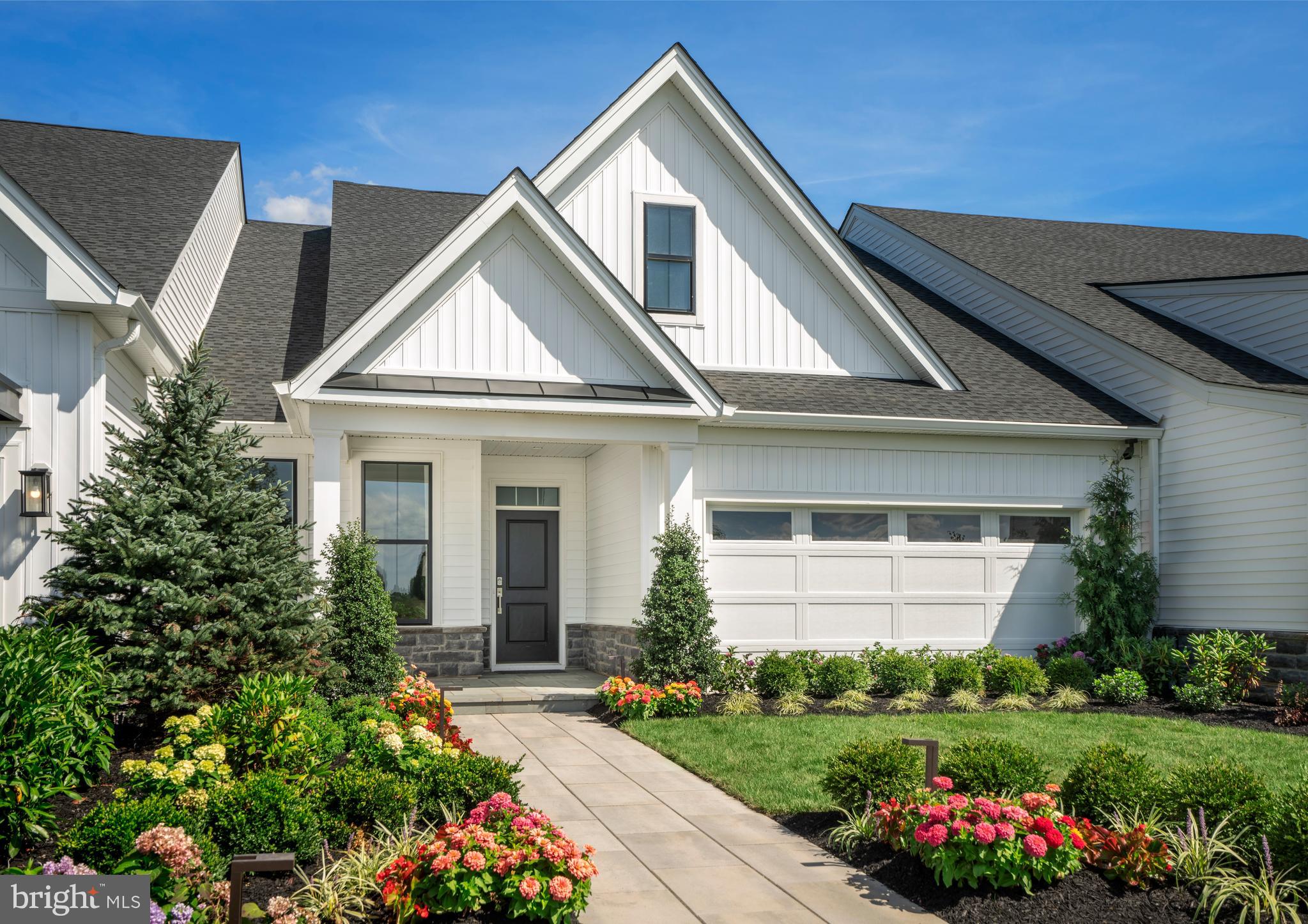 NOW INCLUDING DESIGNER FINISHES! This Quick Move-in Home on homesite 40 can close WINTER 2022/2023! First floor living and a fabulous location in a 55+ Private Community! FIRST FLOOR PRIMARY BEDROOM SUITE! Hurry this will not last long! This DOLINGTON MANOR is 2,300 SF and offers all MAIN FLOOR living plus a finished LOFT and 3rd bathroom! The fabulous vaulted ceiling of your new Great Room is open to a relaxed and comfy Kitchen, which is anchored by a large center island. The Kitchen showcases Gourmet appliances, 42" cabinetry featuring white cabinets with contrasting driftwood-color island cabinets, quartz countertops, ceramic chevron backsplash & large pantry. Plus, there is luxurious wide plank hardwood flooring in all the main living areas. To complete one story living, your first floor Master Bedroom includes a spacious walk-in closet and expanded master bath with 12"x 24" tiled shower with seat, mosaic tile shower floor, quartz countertop, and contrasting 12"x 24" tile floor.  There is also a roomy guest bedroom with walk-in closet and attached bath on the main floor. To complete this home is a 2-car garage, main level laundry room and mud-room entrance. This is an amazing opportunity with a brand new 5700 SF community clubhouse for residents boasting state of the art fitness, outdoor swimming pool, putting green, pickleball and bocce courts! All of this capped off by lawn and snow removal, trash pick-up and much more! 
Decorated model photos for representation - may show optional features.