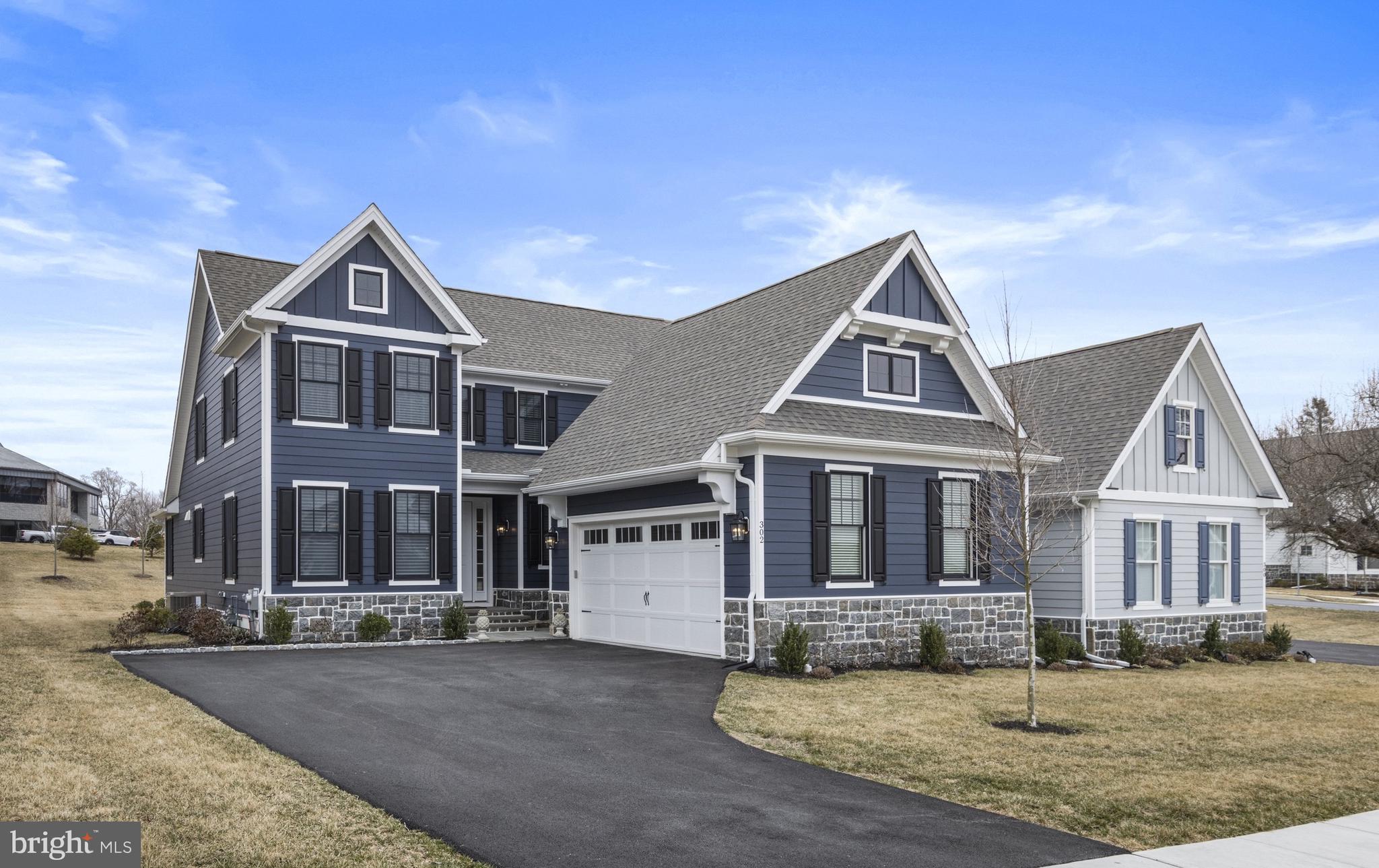 This finely appointed twin is conveniently located close to all of the shopping and desirability of Downtown Kennett Square. This home was constructed less than 2 years ago and offers numerous builder upgrades as well as all of the luxuries of modern living. Enter the main entrance by way of the newly resurfaced slate front steps. Enter into the foyer and immediately notice the hickory hardwood flooring that run throughout the home. Head straight back to find the open Chef's kitchen and family room. The kitchen features loads of upgrades and includes premium kitchen cabinets, Closet by Design walk in pantry, double Thermador ovens, expanded island to seat 4, quartz countertops, induction cooktop (plumbed for gas if needed), custom backsplash, icemaker in island, beverage/coffee bar addition with beverage fridge and butler's pantry with wine fridge. A breakfast area leads to a covered screened porch off of the rear of the home. The kitchen looks over the family room with gas fireplace. The main floor primary suite has been thoughtfully reconfigured to maximize the space and the layout is unlike other homes in the neighborhood. A well-sized bedroom leads to the stunning en-suite featuring a massive walk-in tiled shower with enlarged double head shower, custom primary bath cabinets with dual sinks, separate/private toilet room, enlarged primary bath closet, Closet by Design upgrade in the large walk-in closet. Head up to the second level to find a build-in bookcases and window seat. This level features 3 bedrooms, one with private en-suite and the additional 2 sharing a hall bath. The fabulous lower level provides an abundance of additional living space as well as unfinished storage. The large media room is wide open and has hickory wood floors, wet-bar with beverage fridge and attached island with seating, egress window, optional 5th bedroom/office and full bath. The unfinished space is currently being used as a gym. This home offers one floor living at its finest with expanded footprint in main floor living and dining area. Additional features include Hunter Douglass Silhouette blinds on main floor and lower level, Hunter Douglass wood blinds for upper floor, upgraded faucets in kitchen, bar and bathrooms, large tankless gas water heater, 3-zone heating and cooling with expanded capacity, all windows upgrade and with black exterior, premium paint color on house siding, additional trim on garage doors, additional architectural trim around garage, additional outside outlets, additional electrical wiring to support Electric vehicle charging in garage. Enjoy this low maintenance luxury lifestyle in the heart of Kennett Square.