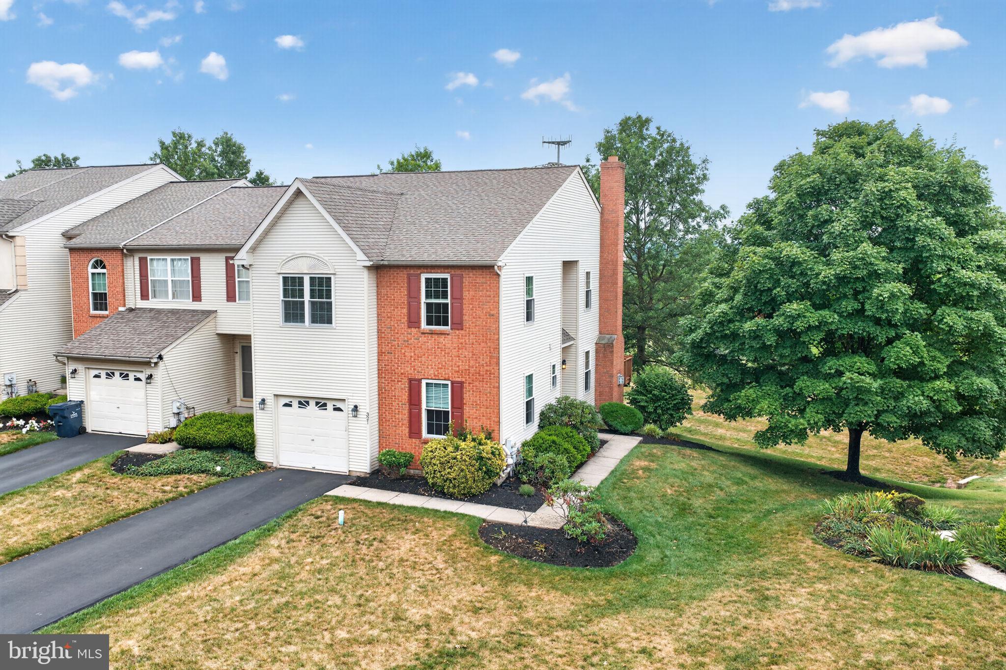 More privacy. More outdoor space. More to love. Perfectly positioned as an end-unit in one of Harleysville's most desirable communities, 321 Hamilton offers the ideal combination of spacious living, thoughtful updates, and the low-maintenance lifestyle today's buyers are looking for.
From the moment you arrive, you'll appreciate the mature landscaping, additional green space, and peaceful setting that make this home stand out. Inside, oversized windows fill the home with natural light, creating warm and inviting spaces designed for both everyday living and entertaining. The spacious living room centers around a cozy fireplace, while the adjoining dining area flows seamlessly to the elevated deck—an ideal spot to enjoy your morning coffee, host friends, or simply relax while overlooking the open surroundings.
The kitchen offers generous cabinet and counter space, making meal preparation both practical and enjoyable, while the adjoining breakfast area provides the perfect place to start your day.
The finished walkout lower level adds an entirely new dimension to the home. Complete with a custom bar, expansive recreation space, abundant storage, and direct access to the patio, it's ready for game days, movie nights, hobbies, a home office, or gatherings with family and friends.
Peace of mind comes standard with significant improvements already completed, including new windows (2025), roof (2013), HVAC (2012), and water heater (2020). Every update reflects the exceptional care this home has received over the years.
Homes offering this combination of privacy, generous living space, major updates, and carefree living don't come along often. The work is done. The setting is exceptional. All that's left is to move in.