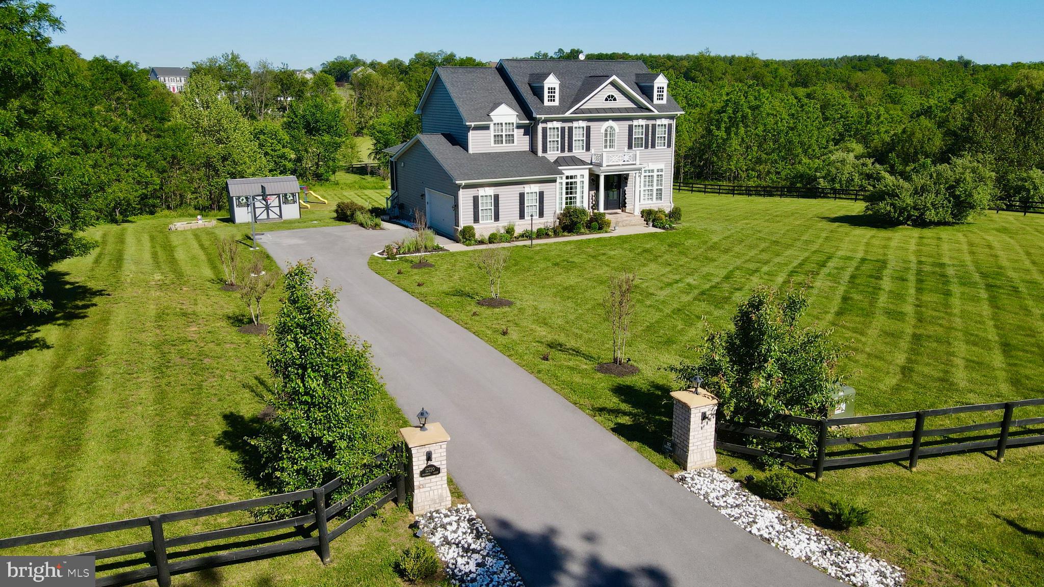 Welcome to 12720 Snowbird Court — an exceptional luxury residence in Lovettsville featuring the highly sought-after Chestnut Grove model by respected builder Carrington Homes. Situated on over 3 acres of professionally landscaped grounds within Eagle Creek Estates, this stunning property offers over 5,000 finished square feet, five spacious bedrooms, four full bathrooms, and one half bath, blending elegance, privacy, craftsmanship, and modern comfort into an extraordinary living experience that includes 250k+ of post closing upgrades.

Set against the scenic backdrop of beautiful Milltown Creek running along the rear of the property, this extraordinary setting offers a rare combination of tranquility, usable land, and privacy that is increasingly difficult to find in Loudoun County. Guests are warmly welcomed at the foot of the private driveway by illuminated stone piers and a custom address plate that immediately set the tone for the elegance found throughout. The fully fenced property provides exceptional outdoor enjoyment and flexibility, while the combination of the custom arched flagstone patio below a generously sized trex deck and covered porch create inviting spaces for entertaining, relaxing, and taking in the peaceful surroundings. The rear grounds offer abundant possibilities for future outdoor enhancements including a poolside retreat, lanai, or expanded entertainment spaces designed to suit your vision.

Inside, the home showcases the quality craftsmanship and upscale finishes Carrington Homes is known for. The open and expansive floor plan is filled with natural light, enhanced by elegant architectural details, and elevated by impressive 10-foot ceilings throughout the main level. Coffered ceilings, extensive custom trim, and arched doorways lead to a private home office complete with French doors, while the spacious living areas are thoughtfully designed for both everyday living and entertaining.

The well-appointed expanded gourmet kitchen features beautifully upgraded quartz countertops, a generously sized center island, farmhouse sink, abundant cabinetry, a new Bosch Dishwasher, separate walk-in pantry, study area, and Roman shades leading to the covered porch, creating both functionality and sophistication at the heart of the home.

An art gallery-style arched hallway leads from the kitchen to the beautifully appointed formal dining room accented with elegant trim details, creating an ideal setting for both intimate gatherings and larger celebrations.

The built-in surround sound system creates an elevated entertainment experience throughout the home. Upstairs, the spacious primary suite offers a luxurious private retreat, while the additional bedrooms and flexible living spaces provide room for guests, home offices, hobbies, or multi-generational living. The upper level also features a desirable Jack-and-Jill bathroom configuration, adding both functionality and convenience as well as the conveniently located laundry with new Samsung top load washer.

Fresh paint throughout the main level, upper-level bedrooms, and bathrooms provides a refreshed and move-in ready appeal.

The finished lower level welcomes you with an abundance of recreational and entertainment space and includes a bedroom, full bath, beautifully appointed theater room, additional storage, versatile finished spaces, and wet-bar-ready for future customization.

Ideally located just minutes from downtown Lovettsville, owners enjoy easy access to charming local shops, restaurants, and everyday conveniences including the new Co-Op grocery store, offering the perfect balance of peaceful estate living and modern accessibility.

This exceptional property offers luxury living, thoughtful design, and the freedom to create the lifestyle you envision — all surrounded by the beauty and privacy of one of Loudoun County’s most desirable settings.