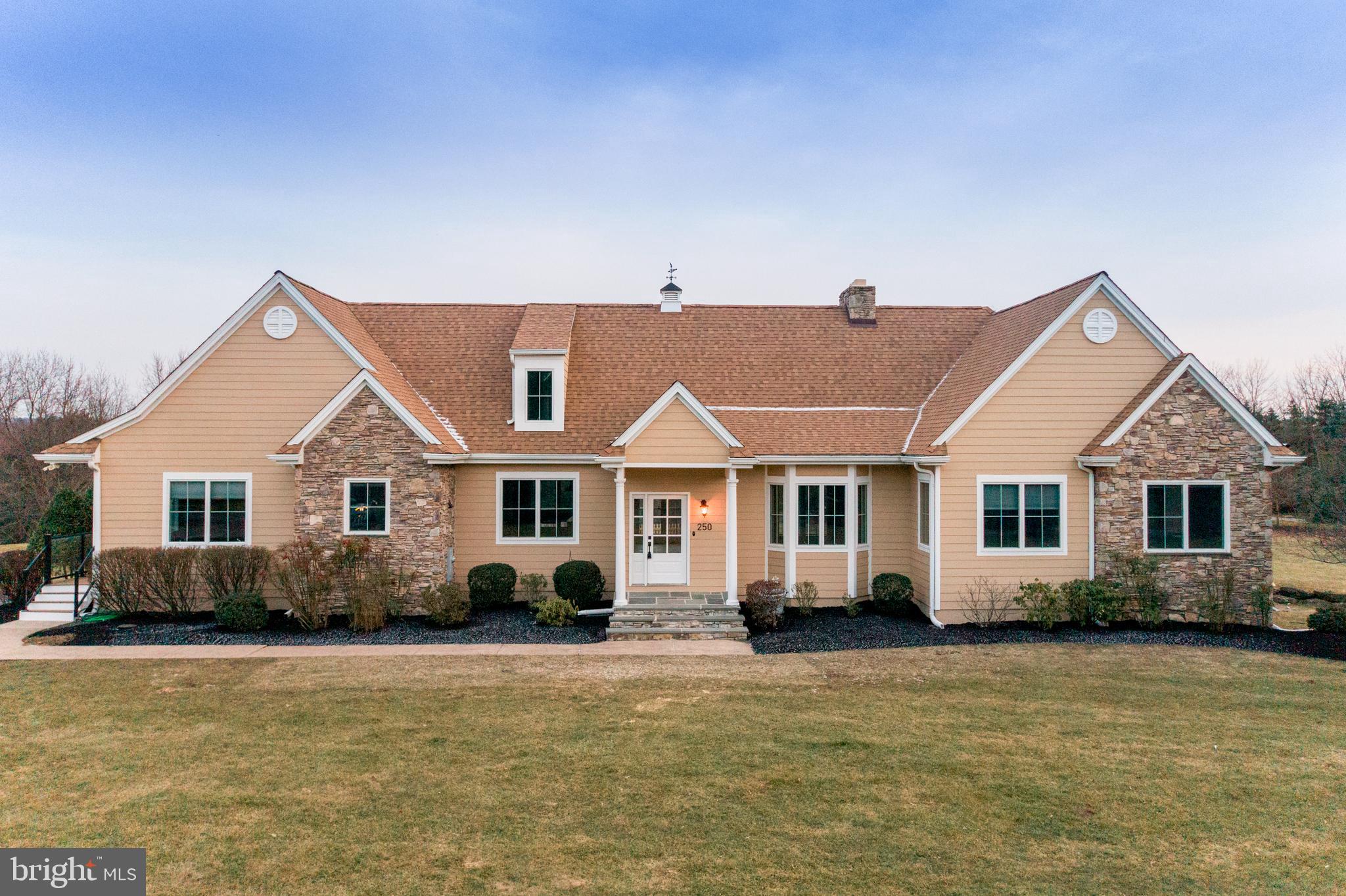 Introducing this absolute stunning, one of a kind, French country manor home sitting on 3.5 acres in the heart of Bucks County! This custom designed home offers one floor living space at it's finest with new hardwood flooring throughout. Sun-drenched and spacious best describes this open and flexible floor plan. A gourmet designed kitchen w/ breakfast area opens to the great room with cathedral ceilings and a statement stone hearth fireplace. The kitchen boasts large island with seating, wood cabinetry and stainless steel appliances, new countertops and backsplash that's perfect for entertaining.  From the living space access the new Timberteck deck. The bedroom wing features a primary suite with large walk-in closet with private full bathroom boasting stall tile shower, Jacuzzi tub, high ceilings and double vanity sink. There are also 3  generous size bedrooms and 1 hall bathroom with tub shower.  Additionally, there is a separate living quarters that can be used as an in-law suite/guest suite flanking the kitchen with vaulted living room space  and has stairs leading to two additional bedrooms. Room to grow with an unbelievable 4000 sq ft unfinished walkout basement featuring stone double sided fireplace. The lovely deck overlooks the salt water in-ground swimming pool with new fence and green surroundings. Stroll over to the 2 bedroom guest cottage complete w/ full kitchen with new vinyl flooring, great room and charming deck. This secluded space is perfect for guests or Airbnb rental or use as a home based business! If you're looking for something special and want to enjoy the spectacular views, this home truly has it all! Also worth mentioning- there are 2 Generac backup generators so you never have to worry about power outages, new well line, new lifetime roof, new heating and air, entire interior and exterior of this home has been repainted. This home is located in the award winning Council Rock School district.