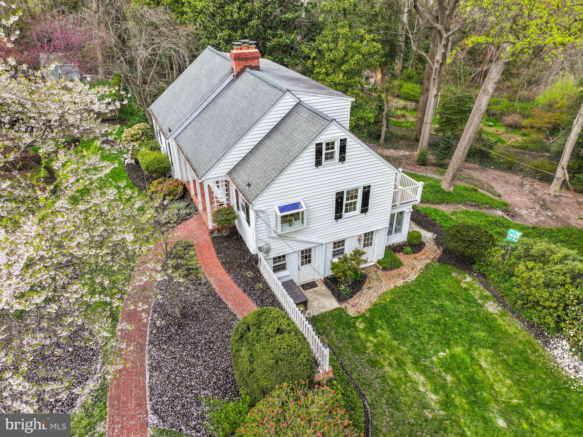 Nantucket style Cape Cod home perfectly located to capture the winter waterviews. Perched on an elevated 0.94 acre lot bordered by trees and overlooking Sullivan Cove this 4 bedroom 3 bath home combines cottage charm with modern amenities.  Updated kitchen and baths compliment the preserved architectural details and pine wood floors. Charming details including built-in cabinetry, window seat, lower level coved ceiling,  and decorative wood moldings enhance the appeal. The main level features an all white kitchen with high-end appliances and adjoining dining area which flows into the Living room with fireplace. Two spacious bedrooms with shared hall bath offer one level living.  Upstairs an additional 2 bedrooms and beautifully remodeled bath provide plenty of space for family and friends.  Natural light floods into the lower level through the walls of windows overlooking the backyard and play area. With a large living area, conveniently located half bath, built-in desk area,  and laundry room, the space is filled with endless uses for the whole family.  Located in the coveted Linstead on the Severn community, this sought after neighborhood boasts walking paths with multiple community beaches including the main beach with swimming area, pavilion, firepit, playground, and community pier with boat slips, boat ramp, mooring area, and kayak rack with launch area. The year round social activities makes everyday feel like a vacation. Walkable to shops, restaurants AND in the Blue Ribbon Severna Park school district, this property has everything you are looking for. Welcome Home!