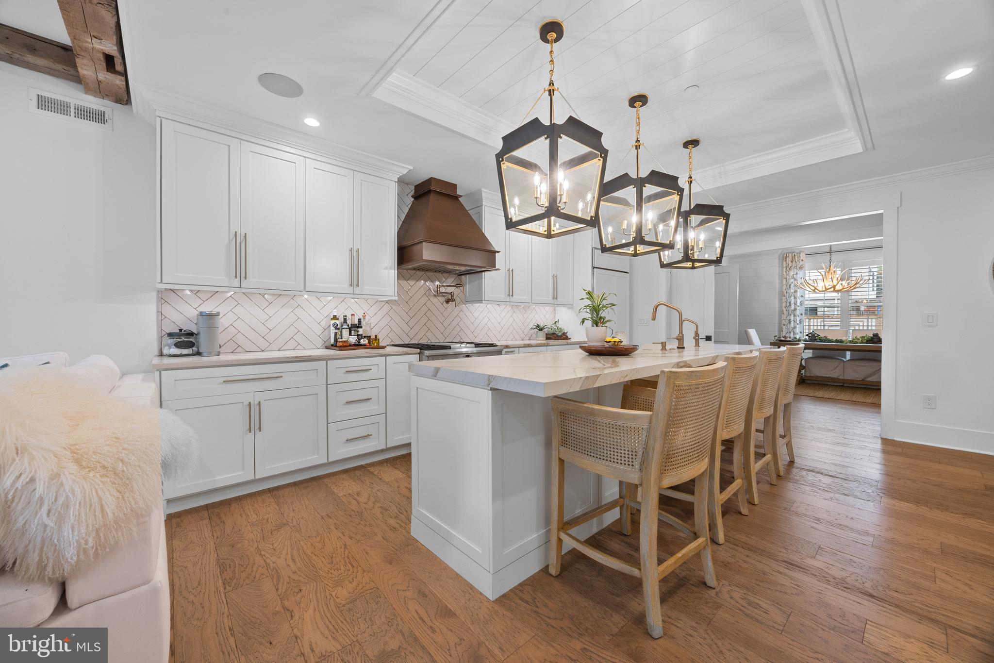 Stop Your Search! Your Dream Home Awaits at 4724 Cross Street! This stunning 2020-built townhome by renowned local builder Denise Lehmann redefines luxury living. Tucked away on a private street in Manyunk, it offers the perfect blend of comfort, cutting-edge sustainability, and serene privacy across three bedrooms and five bathrooms.

Step inside the entry floor to discover a huge flexible-use room, a full bathroom, and direct access to your one-car garage along a path of custom brick pavers. The first floor is an entertainer's delight, showcasing a gourmet kitchen with an oversized island and top-of-the-line GE Monogram appliances, a spacious living area, and a large dining room complete with a wet bar. A discreet powder room and a tranquil private deck extend your living space outdoors.

The second floor offers two expansive bedrooms, each with its own en suite bathroom for ultimate privacy. One bedroom ingeniously features a Murphy bed, perfect for a home office or guest space. A large laundry room with a sink adds to the convenience.

Prepare to be swept away by the third-floor owner's suite – your personal sanctuary. Enjoy a dedicated wet bar, refrigerator, and an opulent, spa-inspired bathroom featuring a free-standing tub and separate toilet room. A custom walk-in closet and versatile bonus room provide ample space for your needs.
But the true crown jewel? The green roof deck. This incredible outdoor living room is equipped with a wet bar, refrigerator, fire pit table, television, and offers unparalleled city views – ideal for entertaining or quiet relaxation.

This home isn't just beautiful; it's smart. Benefit from a two-zoned Geothermal heating and cooling system for incredible energy efficiency, Hunter Douglas one-touch blinds for effortless light control, a reverse osmosis water filtration system, custom vanity sinks, and a Sonos whole-home sound system. And for even more savings, there are five years remaining on the tax abatement! Schedule your showing to see this beautiful property which may be the perfect fit for your next home.