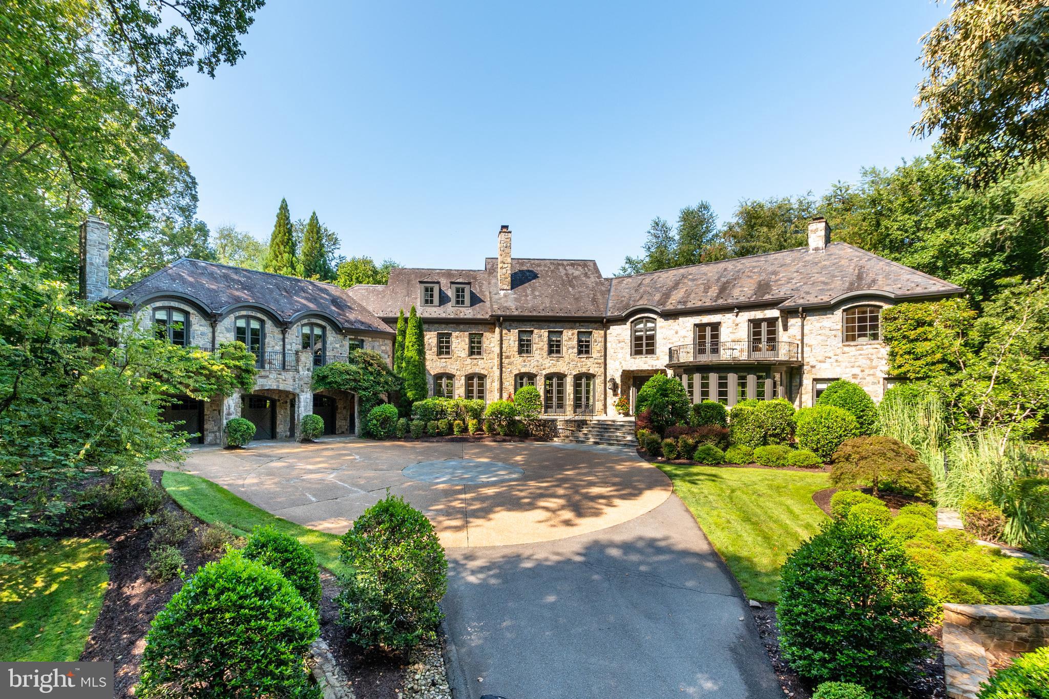 448 River Bend Rd is impressive in scale and design, with breathtaking sight lines and refined architectural details at every turn. Beautifully presented on 5 acres in Great Falls, this estate prominently spans a total of 19,250 SF and includes 7 Bedroom Suites, 9 Full Baths, and 3 Half Baths. The entire residence consists of an exquisite Main House, a Pool House, an attached 3-Car Garage, a Swimming Pool, Basketball Court, and a Private Dock (estimated 250'+ of water frontage). Built to welcome future generations, this incredible home has amazing character and something special for everyone. The thoughtful design of this immaculate property takes into consideration its serene surroundings. Each well-placed window frames the picturesque views and the soaring ceilings welcome multiple exposures of natural light to accent the gleaming floors, decadent millwork, and lavish stone selections. There are 8 fireplaces, each with an elegantly designed mantle. Illustrious entertaining spaces set the tone for memorable gatherings as each generously sized room flows seamlessly and with purpose. The Foyer is a stunning tunnel of light that is illuminated by 27 windows that perfectly frame the main helical staircase. The East Wing of the home begins with the Formal Living Room, a bright space where the warm woodwork dovetails the handsome stone tile floors to create a lovely atmosphere to welcome guests. The private Study is adjacent to the Living Room and is rich with custom built-ins that line the walls. The West Wing is comprised of the Formal Dining Room that extends out onto the front Terrace by way of three sets of French Doors. Across the Gallery from the Dining Room is the considerable Family Room that boasts views of the backyard.   The Gourmet Kitchen has an adjoining Breakfast Room that also showcases French doors to the front Terrace. Well-appointed and designed with every caliber Chef in mind, the Gourmet Kitchen is complete with Viking and Miele appliances, a double sink, two task sinks, two dishwashers, two refrigerators, double ovens, warming drawers, and a coffee bar with wine refrigerators. An added Chef’s bonus is the Outdoor Kitchen that is accessible through the sun-filled Den. The household corridor has a secondary staircase, one of two Laundry Rooms, a Powder Room, a Mud Room, and access to the attached 3 Car Garage.  There are five Bedroom Suites sequestered on the Upper Level, including a marvelous Primary Suite that is comprised of a Sitting Room, Office Nook, Private Balcony, Dressing Room, and a luxurious En-Suite Bath. The Primary Bath has separate vanities, a soaking tub, separate shower, and a water closet. There are three secondary Bedroom Suites that each have a private Bath, custom built-ins, and great closet space. One of the most enviable features of the Upper Level is the open Workspace/Homework Room that has a whimsical spiral staircase to the Upper Level Play Room. There is an intimate Office that opens to a Balcony. The Guest Suite is quietly situated at the end of the Hall and is a wonderful retreat for visitors. Expansive and drenched with natural light, this Guest Suite is accented by a fireplace, a Full Bath with a soaking tub, a Balcony, and a convenient separate entrance.  The Lower Level is approximately 5150 SF of finished living space that has been outfitted to entertain. The main staircase leads you into the Bar Room that houses a full-size Bar that seats up to ten. There is a Den with access to a Wine Cellar, a Billiards Room, an Exercise Room, Theater, and Recreation Room. A private Au Pair Suite with a Full Bath is also on this level. Through the Billiards Room is access to a side Patio.  The separate Pool House is comprised of a Living Room/Party Room with a Full Kitchen and Full Bath on the Main Level. The Lower Level has a Bedroom with an En-Suite Bath and walkout access to a Patio.
