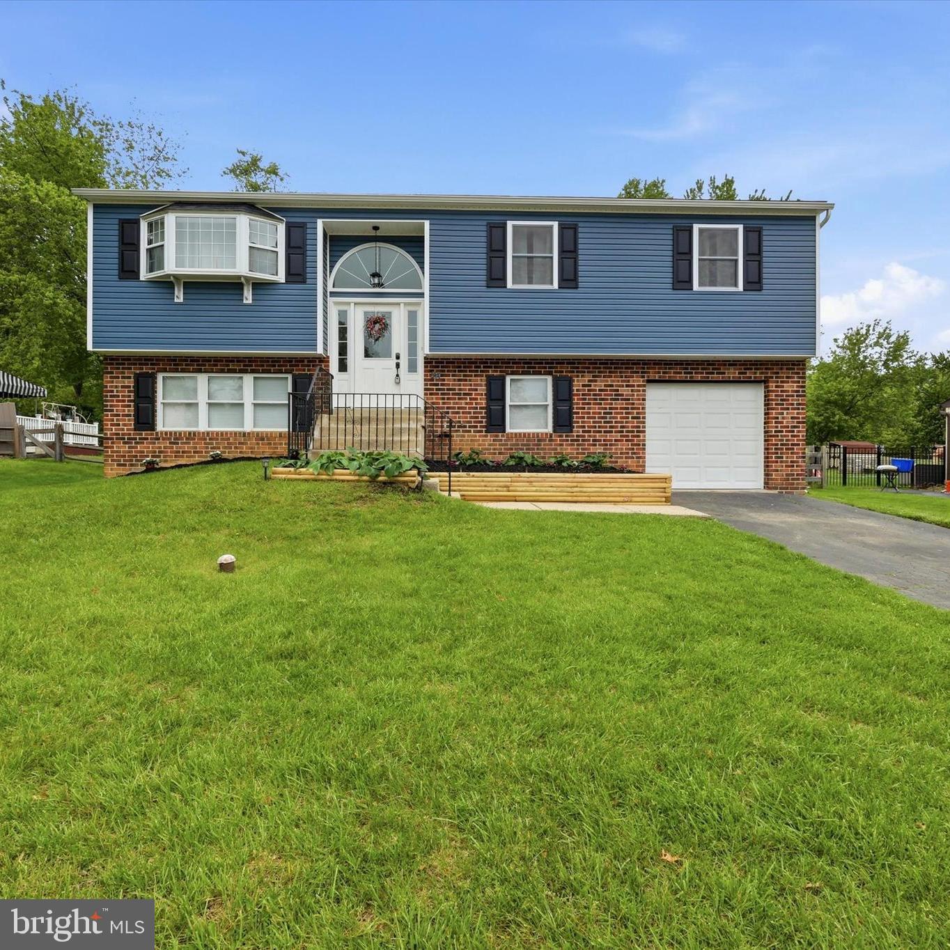 This well-maintained and thoughtfully upgraded single-family home offers beautiful cosmetic updates along with major mechanical improvements throughout. Move-in ready, this home features a stunningly updated kitchen (2023) with modern finishes, solid surface countertops, ample cabinetry, and stainless-steel appliances. The kitchen is open to the living and dining areas, creating an ideal flow for everyday living and family gatherings. The main level also includes three spacious bedrooms and an updated full hall bath. The lower level offers a large family room, a fourth bedroom, powder room, and a laundry area with access to the attached garage. Step through the french doors from the family room into the expansive fenced backyard that is simply perfect for pets and play. The outdoor space is highlighted by a large above-ground pool with a beautiful attached Trex deck (2025) , creating the perfect retreat for summer relaxation and entertainment. Additional updates include a new roof (2020), new fence (2021), new patio (2021), new HVAC system (2024), and new siding ((including ZIP system sheathing), front and rear doors and windows (2025). All of this provides both peace of mind and enhanced energy efficiency so the only thing you will have to do is unpack and enjoy! Note...some pics are virtually staged.