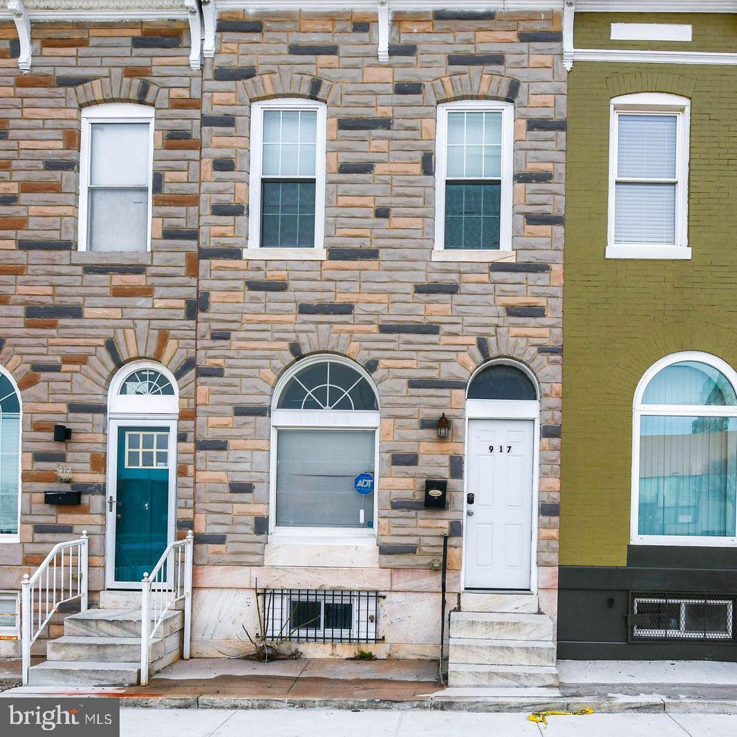 TWO Primary Suites + Walkout Basement Income Suite — Steps from Johns Hopkins! This is the house-hack or turnkey investment you have been waiting for. Live in one primary suite, rent the other, and let the walkout basement suite cover the rest of your mortgage.

Welcome to 917 N Patterson Park Ave — a beautifully renovated rowhome in the heart of Baltimore's East Baltimore revitalization corridor, just minutes from Johns Hopkins Hospital and Eager Park. Whether you are a medical professional seeking a zero-commute lifestyle, a savvy first-time buyer or not looking to offset your mortgage with rental income, or an investor targeting the booming travel nurse market, this floor plan was built for you.

Inside, you will find a bright, open-concept main level that flows effortlessly from the living area to the dining space. Upstairs delivers a rare and highly coveted layout: two private primary suites, each with its own dedicated full bathroom — perfect for a roommate, a live-in family member, or a short-term rental guest. The fully finished walkout basement adds a third bedroom and full bathroom with its own private entrance, creating a genuinely income-producing unit within your own home.

The comprehensive renovation — completed just five years ago — means everything feels like newer construction without the new-construction price tag. The fenced backyard is ready for weekend gatherings, pets, or quiet evenings, and the location puts you within minutes of the Johns Hopkins campus, Eager Park, and the broader East Baltimore development zone that continues to attract investment and appreciation.

Priced aggressively for a quick, as-is sale. Schedule your private showing today — properties with this layout do not last.