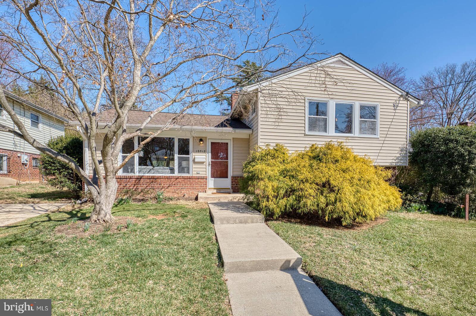 Offer deadline set for Thursday, April 3rd, at 5 PM. Welcome to 10313 Inwood Ave, a beautiful split level in the highly desirable Forest Estates. The main level boasts a seamless flow between the open concept living room, dining room, and kitchen with hardwood flooring, highlighted by vaulted ceilings with exposed wood beams and recessed lighting. The kitchen features granite countertops, 42-inch cabinetry, stainless steel appliances, and an island with a breakfast bar. A large picture window floods the living room with natural light. The sunroom, located off the dining area, features ceramic tile flooring, a convenient side door opening to the fenced yard and patio, and peaceful views of the backyard—perfect for relaxing. On the upper level, there are three generously sized bedrooms with hardwood floors and a luxurious full bathroom, complete with a jetted tub, standing shower, double sinks, and ceramic tile flooring. The lower level provides even more living space, including a cozy carpeted recreation room with a wood-burning fireplace and built-in shelving. The lower level also has a convenient laundry room, additional full bathroom, rear door to the fenced back yard, and tons of extra room for storage in the crawl space. Great location! Under a mile to the Forest Glen metro station (red line) and access to 495, perfect for commuters. Walking distance to Sligo Creek Trail and multiple parks. Close distance to all the shopping and restaurants in Downtown Silver Spring and Wheaton. Don't miss this opportunity!