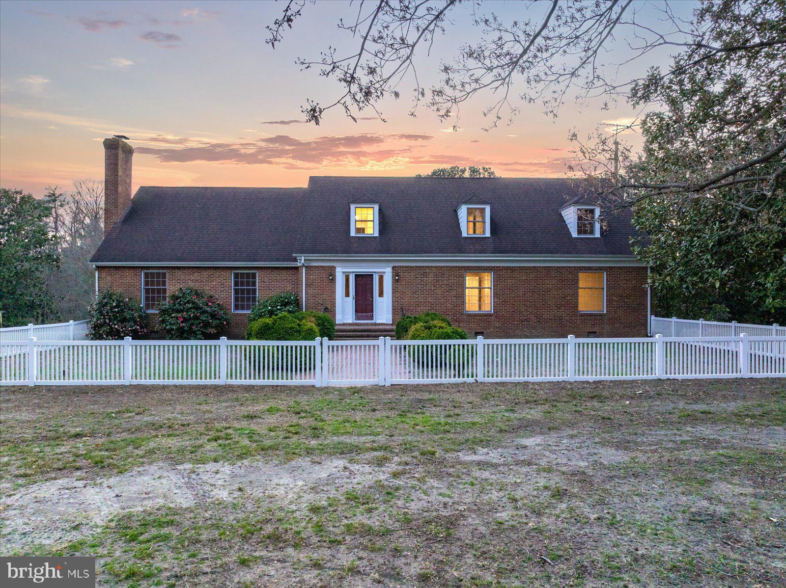 Tucked down a long, tree-lined drive, this one-of-a-kind estate spans 7.92 acres, offering a private country setting with no direct neighbors and a level of peace and seclusion that’s hard to come by.

The property is thoughtfully laid out with a stately brick residence, a private pond complete with its own dock, barn, and multiple outbuildings—creating the perfect setup for equestrian use, hobby farming, or simply enjoying wide open space with purpose.

Inside, the home offers over 4,600 square feet with a layout that feels both spacious and functional. Rich mahogany walls, original hardwood floors, and detailed millwork—including crown molding, chair rail, and wainscoting—bring warmth and character throughout. Two fireplaces anchor the main living areas, while the main level features a primary suite along with two additional bedrooms. Upstairs, you’ll find three more bedrooms, bonus spaces, and generous storage—flexibility for a variety of living arrangements.

Two enclosed three-season sunrooms overlook the water and surrounding landscape, offering a natural extension of the living space—ideal for quiet mornings, evening wind-downs, and taking in the view year-round.

The land itself is a standout feature. Open space provides room for pasture, recreation, or future vision, while the pond and dock create a peaceful focal point that truly sets the tone for the property.

All of this is just minutes from downtown Salisbury, TidalHealth Peninsula Regional, and Salisbury University, with easy access to Route 50 for travel to the beaches or metro areas.

As an added bonus, the property sits directly across from Pemberton Historical Park, offering access to miles of scenic trails, riverfront views along the Wicomico, open green space, and year-round events—all just moments from your front entrance.

A setting like this rarely becomes available—private, established, and positioned for both convenience and quiet living.