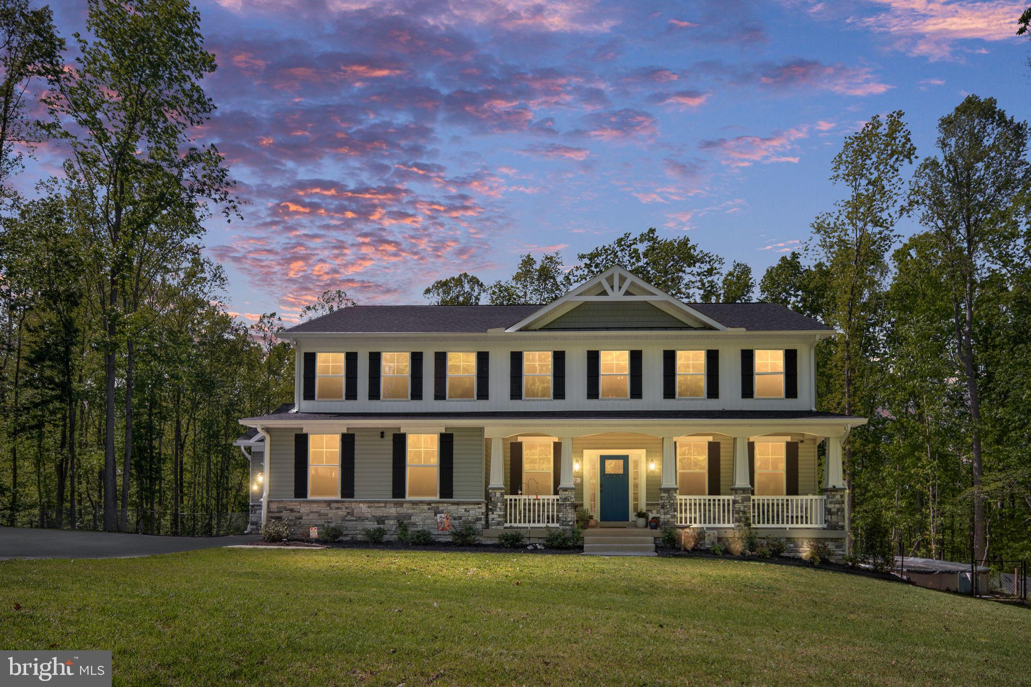 Escape to your own private Stafford retreat with this extraordinary LIKE NEW custom home on 10+  acres with a three-car garage and access to the Rappahannock River! Tucked away down a long private drive lined with blooming cherry blossoms and fruit trees, this stunning property offers the perfect blend of luxury, privacy, and endless future potential. From the moment you arrive, you’ll appreciate the expansive paved parking area, beautifully manicured grounds, and inviting covered front porch that welcomes you home. Inside, this exceptional residence shows like a model and is loaded with upscale finishes throughout—including Luxury Vinyl Plank flooring, custom trim work, brushed nickel finishes, crown molding, and soaring 9-foot ceilings. The gourmet kitchen is truly the heart of the home, featuring a massive quartz island, herringbone tile backsplash, gas cooktop with pot filler, custom vent hood, double ovens, farmhouse sink, walk-in pantry, and stainless steel appliances throughout. Designed for both entertaining and everyday comfort, the kitchen flows seamlessly into the elegant dining area with coffered ceilings, sunroom, and spacious family room highlighted by an arched entryway and stunning gas fireplace with stone surround. The thoughtfully designed main level also offers a mudroom with custom built-ins, easy access to the oversized three-car garage, and a convenient half bath. Upstairs, you’ll find four spacious bedrooms including an incredible primary suite featuring tray ceilings, a private sitting area, oversized walk-in closet, and a luxurious spa-inspired bathroom complete with double vanities, soaking tub, and oversized walk-in tile shower. The upstairs laundry room adds convenience with a utility sink and additional custom storage. The fully finished walkout basement expands your living space even further with a large recreation room, fifth bedroom, and abundant storage space. Step outside and experience the lifestyle this property was designed for. Enjoy peaceful wooded views from the expansive wraparound patio with extensive hardscaping, Trex decking, outdoor lighting, and a custom fire pit area. Cool off in the above-ground pool, tend to your raised garden beds, or harvest from your own peach, plum, apple, pecan, and blackberry trees and bushes. The fenced backyard offers plenty of room for pets, recreation, future expansion, workshops, barns, or even hobby farming opportunities. This remarkable 10-acre property also features a creek running through the land and private community water access that allows you to kayak, fish, and explore Richland Run and the Rappahannock River right from your own neighborhood—creating a truly rare outdoor living experience. Conveniently located near the brand-new Hartwood High School opening this fall, with easy access to commuter lots, Route 17, Warrenton Road, shopping, dining, Walmart, and Lidl, this property offers the perfect combination of privacy and accessibility.  Whether you’re dreaming of a private estate, multi-generational living, homesteading, outdoor recreation, or simply room to grow, this one-of-a-kind property offers endless possibilities. Opportunities like this are incredibly rare—schedule your private tour today and experience everything this exceptional home has to offer!
