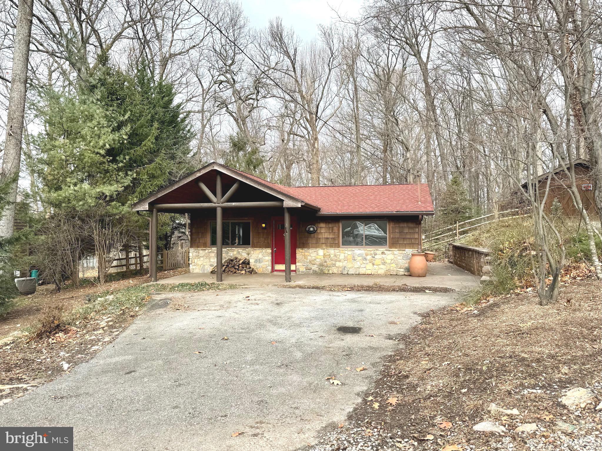 ***MULTIPLE OFFERS- All offers due by 8pm 1/16/24. ***Absolutely CHARMING! Hurry!  2 bedroom, 1.5 bath rancher nestled on over half an acre in Shannondale. Affectionately referred to as Dogwood Cottage, this home has lovely accents fitting for its locale including a beautiful stone retaining wall, cedar shakes, stonework, and a large rustic covered porch with columns. There is a large detached shed and detached run-in on this partially wooded property. Step inside to your warm, inviting living room and cozy up near the wood stove. The kitchen is spacious and open with an incredible picture window, dining area, brand new stainless appliances, and granite counters. There is a screened-in porch and two large decks perfect for enjoying the serenity of your back yard. Brand new flooring, fresh paint & some upgraded fixtures... this home is ready to move right in.